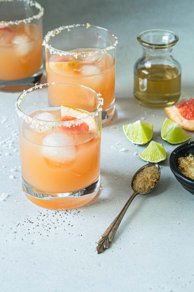 Three grapefruit margaritas with citrus salt and simple syrup