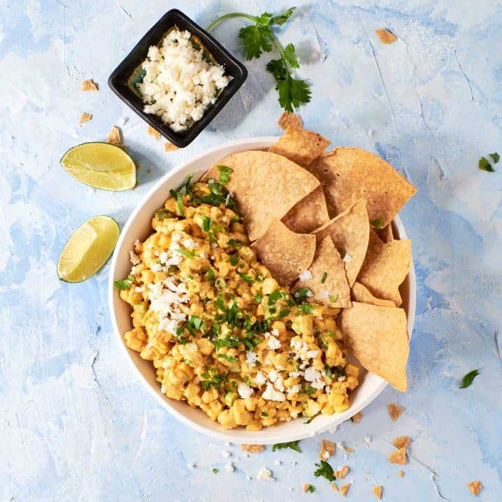 Overhead photo of street corn dip in a white bowl