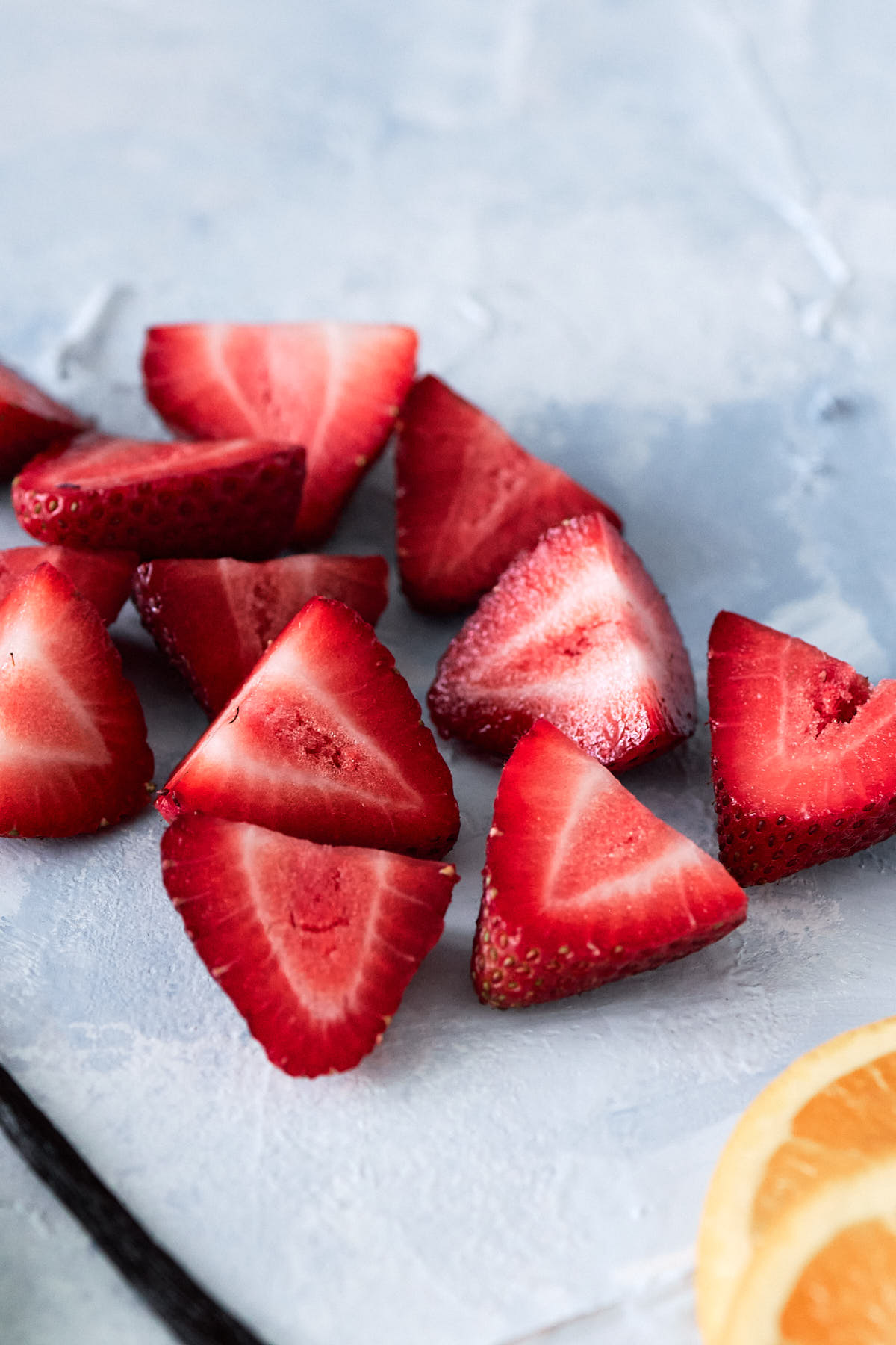 Halved strawberries on a light blue background