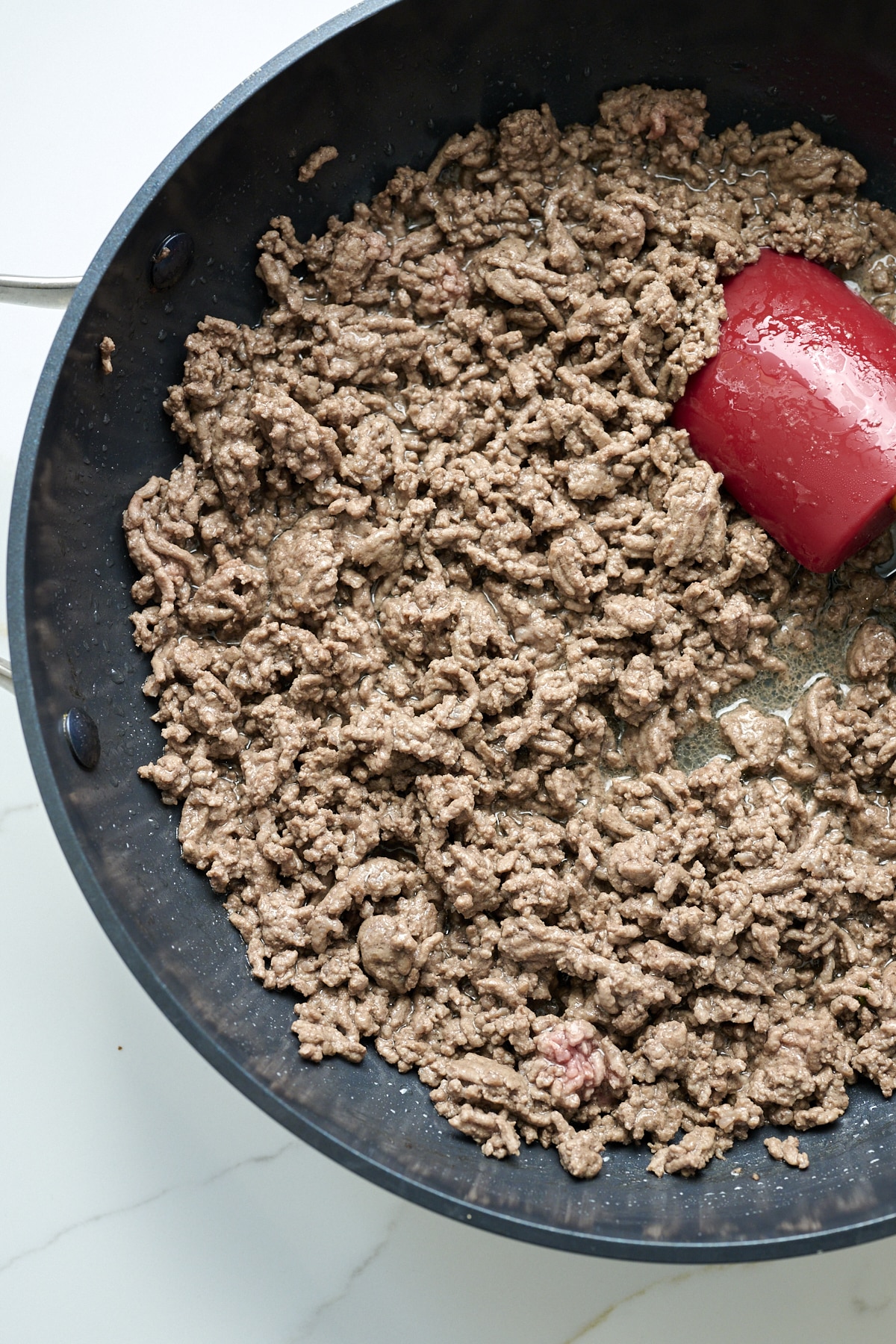 Ground beef browning in a skillet