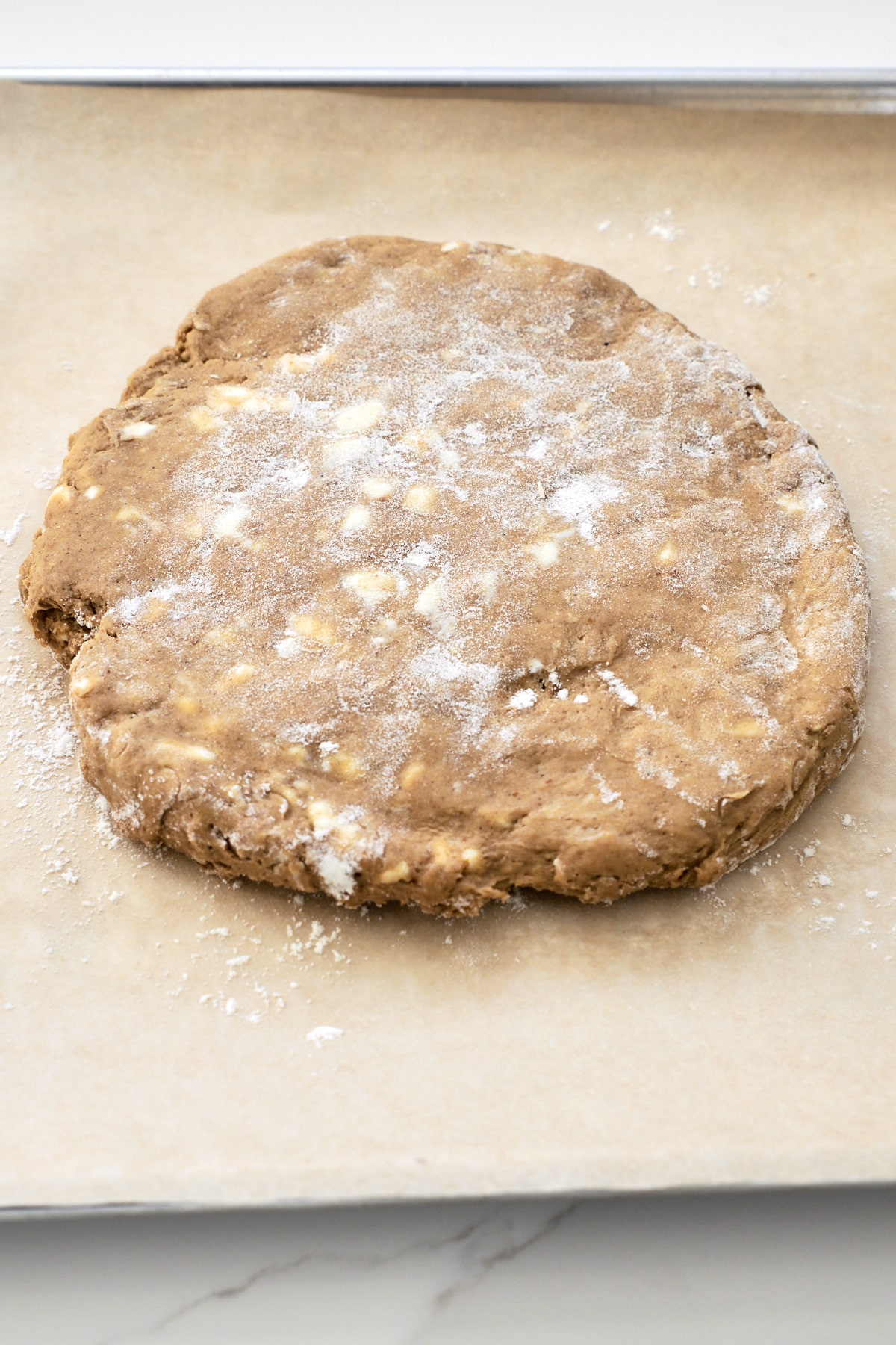 Pumpkin scone dough pressed into 8" disc