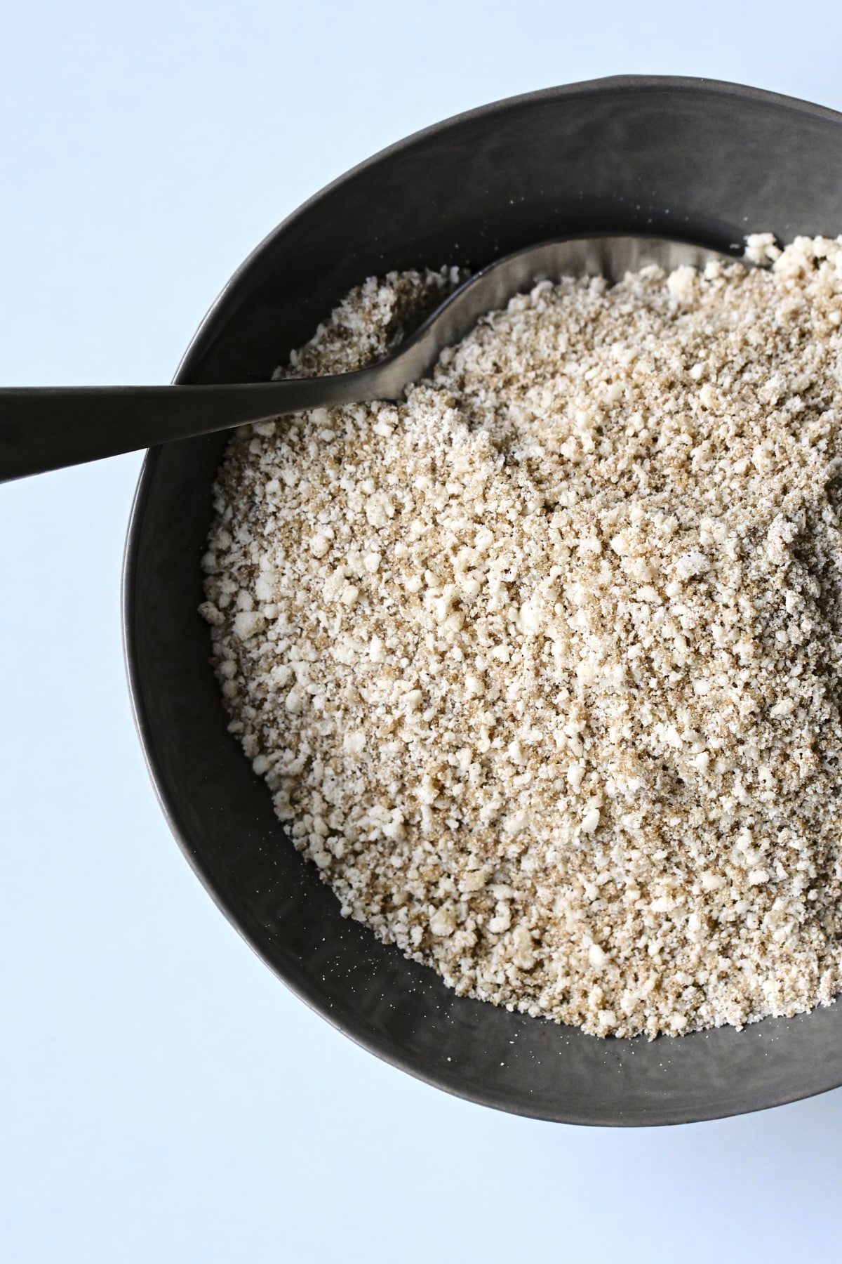 Streusel topping mixture in a dark grey bowl