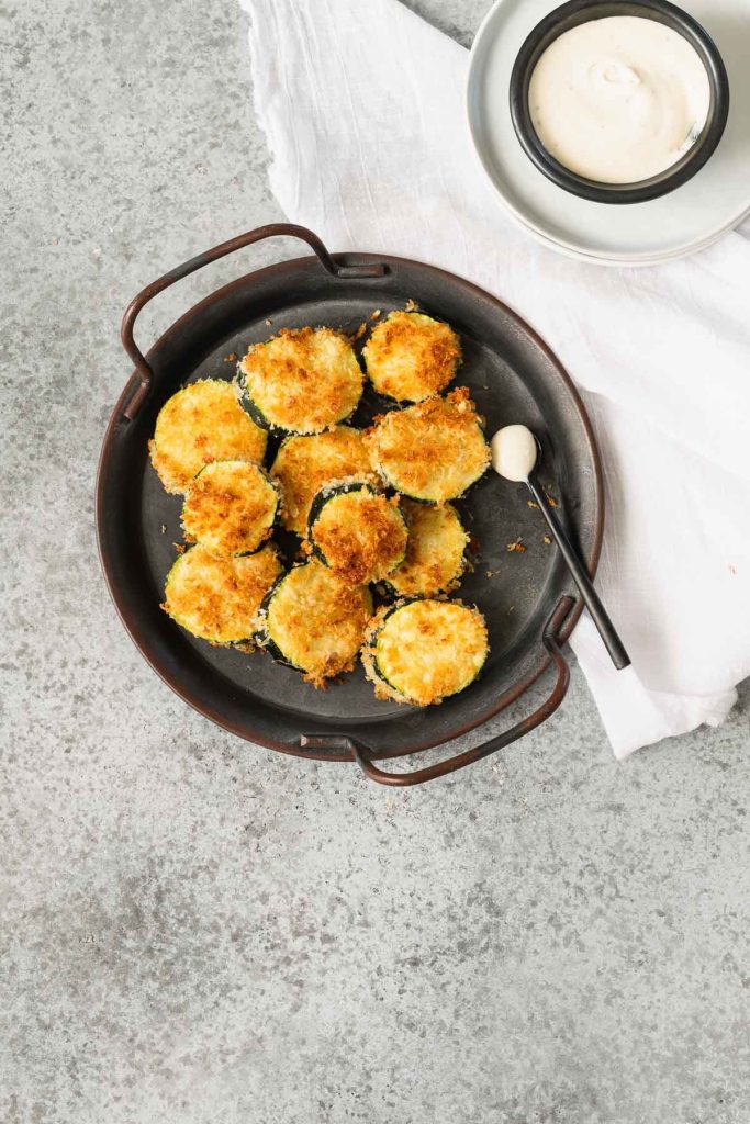 Air fried zucchini chips on a small metal platter with handles