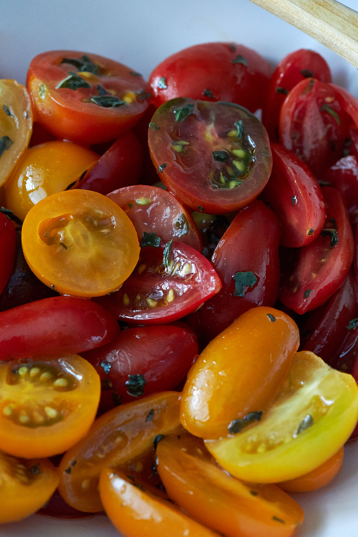 Close up shot of sliced red, orange and yellow grape tomatoes