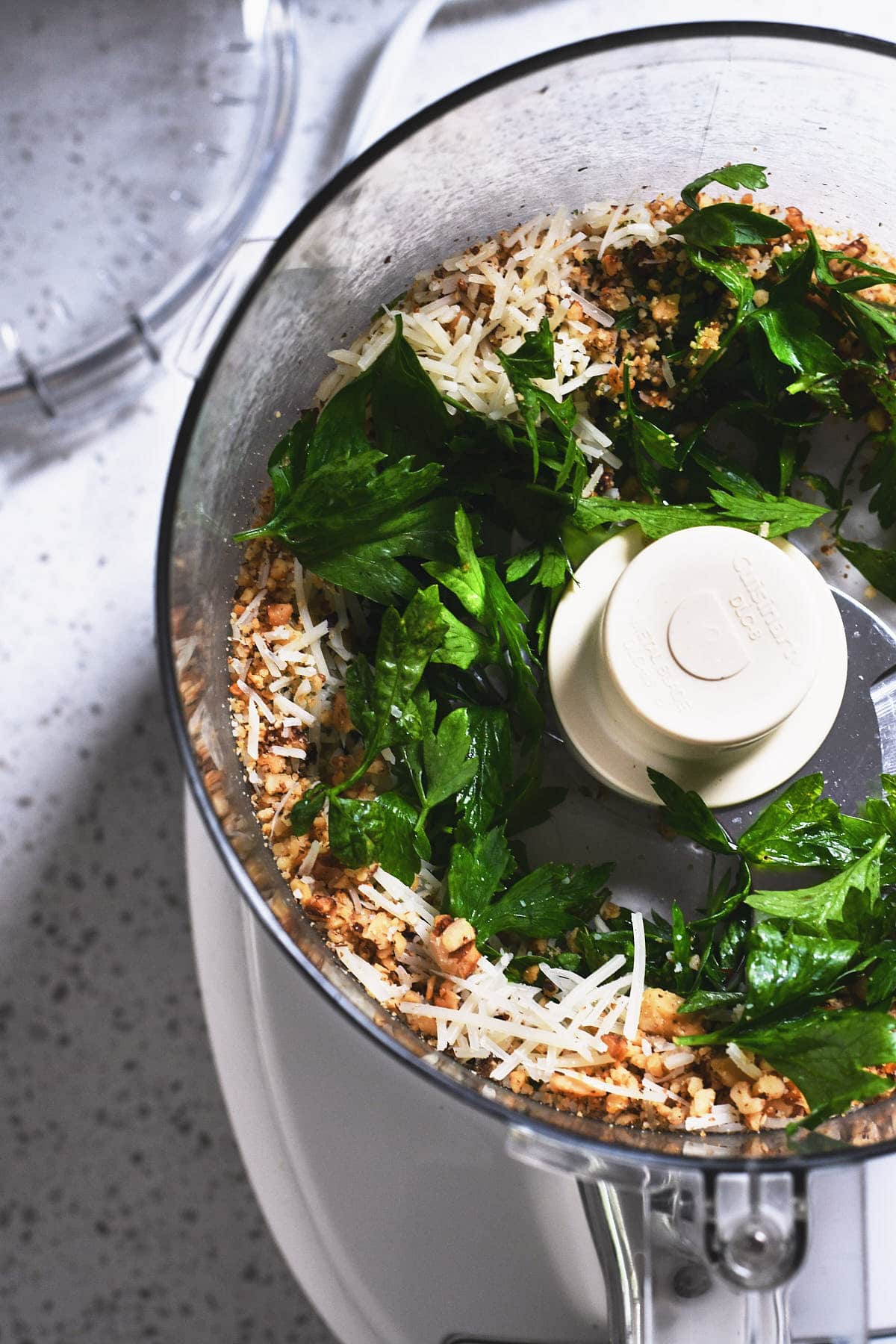 Pesto ingredients in a food processor