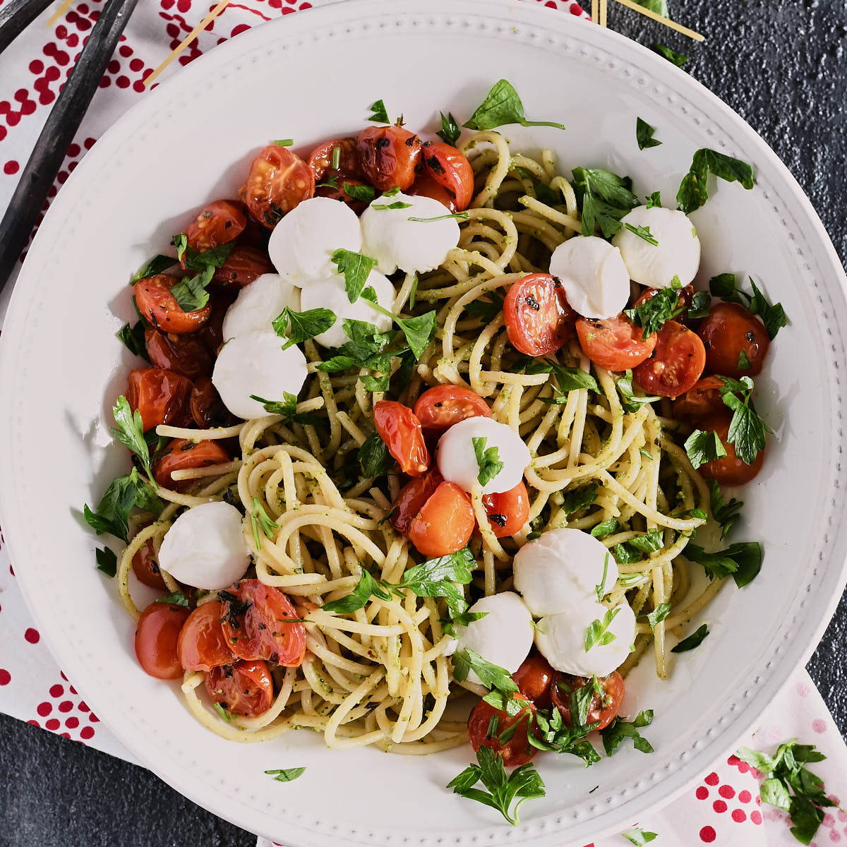 Overhead shot of a bowl of spaghetti topped with roasted tomatoes