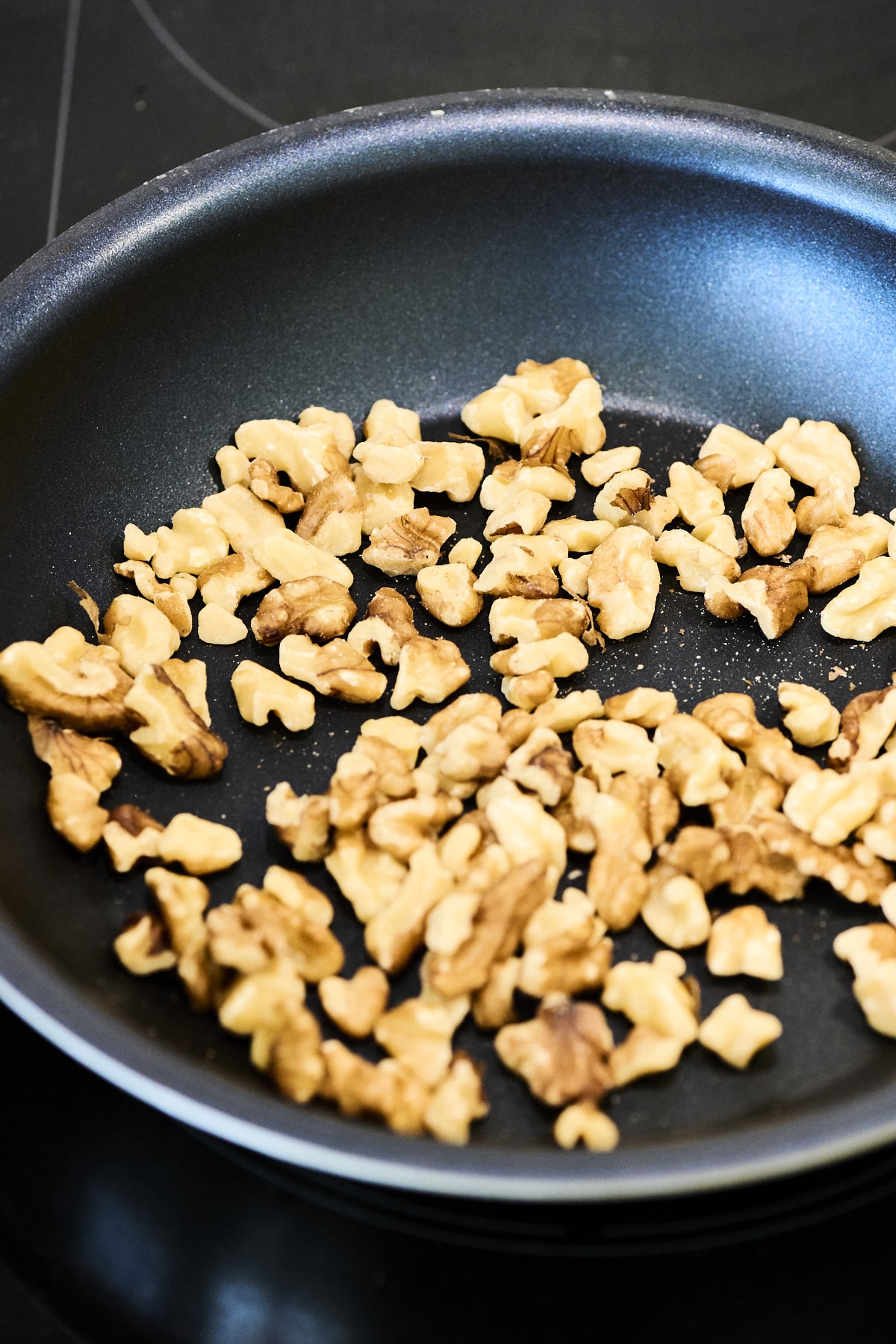 Walnuts toasting in a pan