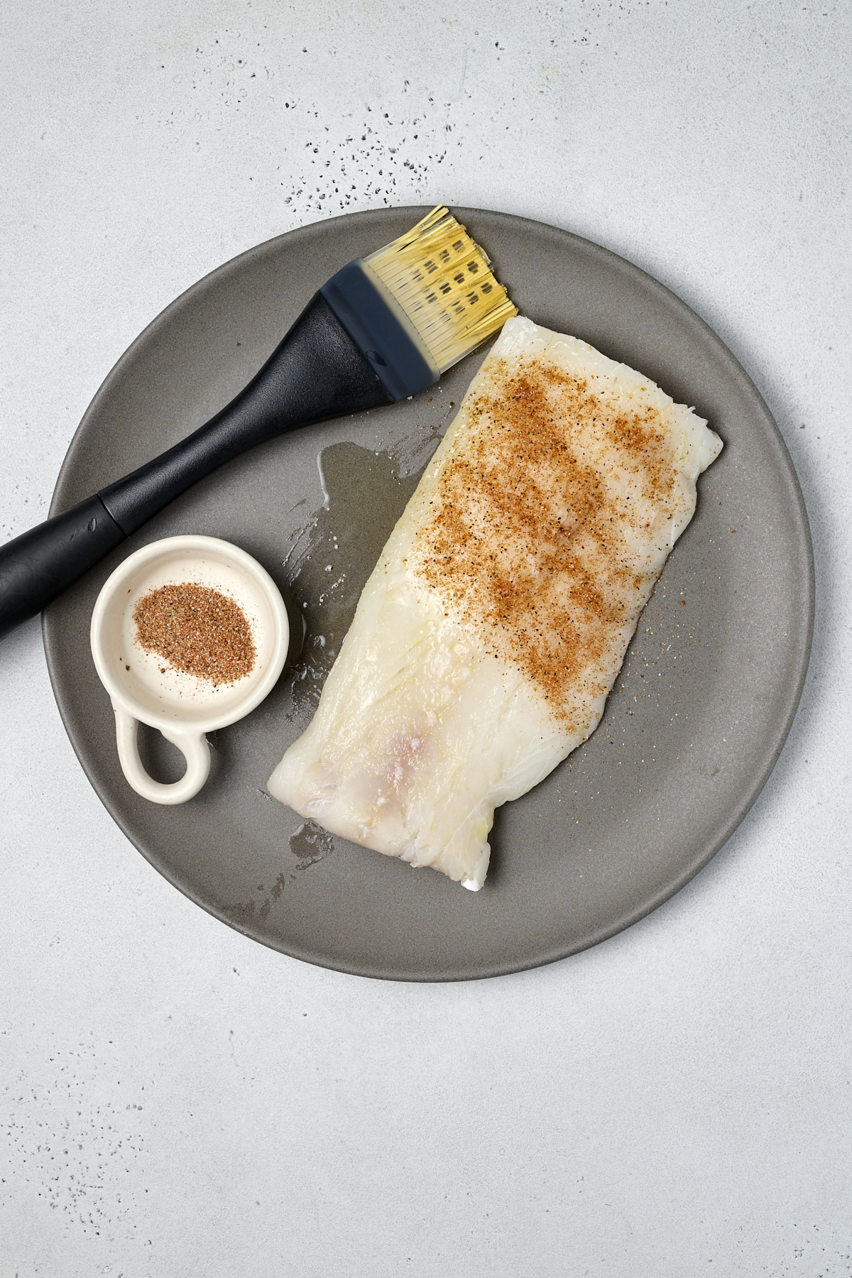 seasoned fish for tacos on a grey plate