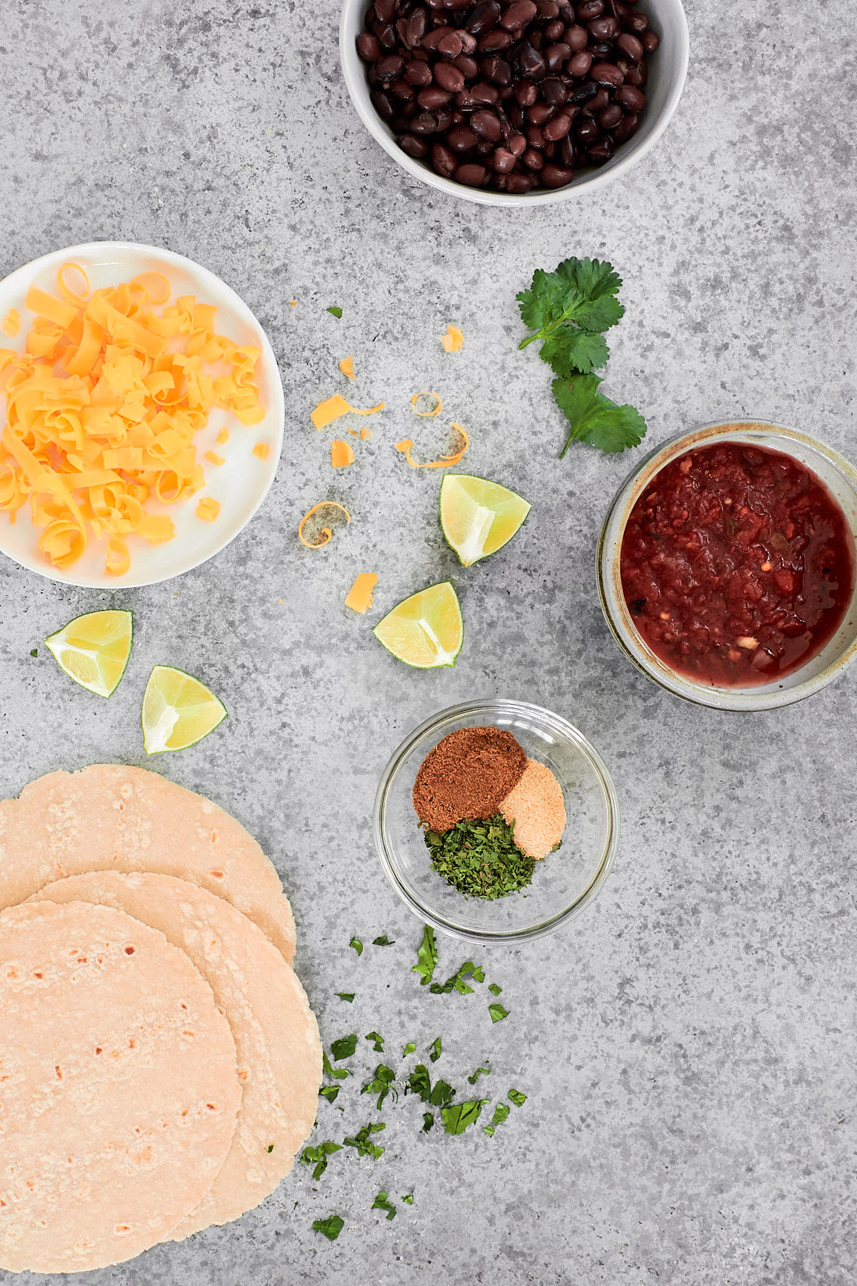Taco ingredients | corn tortillas, cheese, black beans, salsa + spices