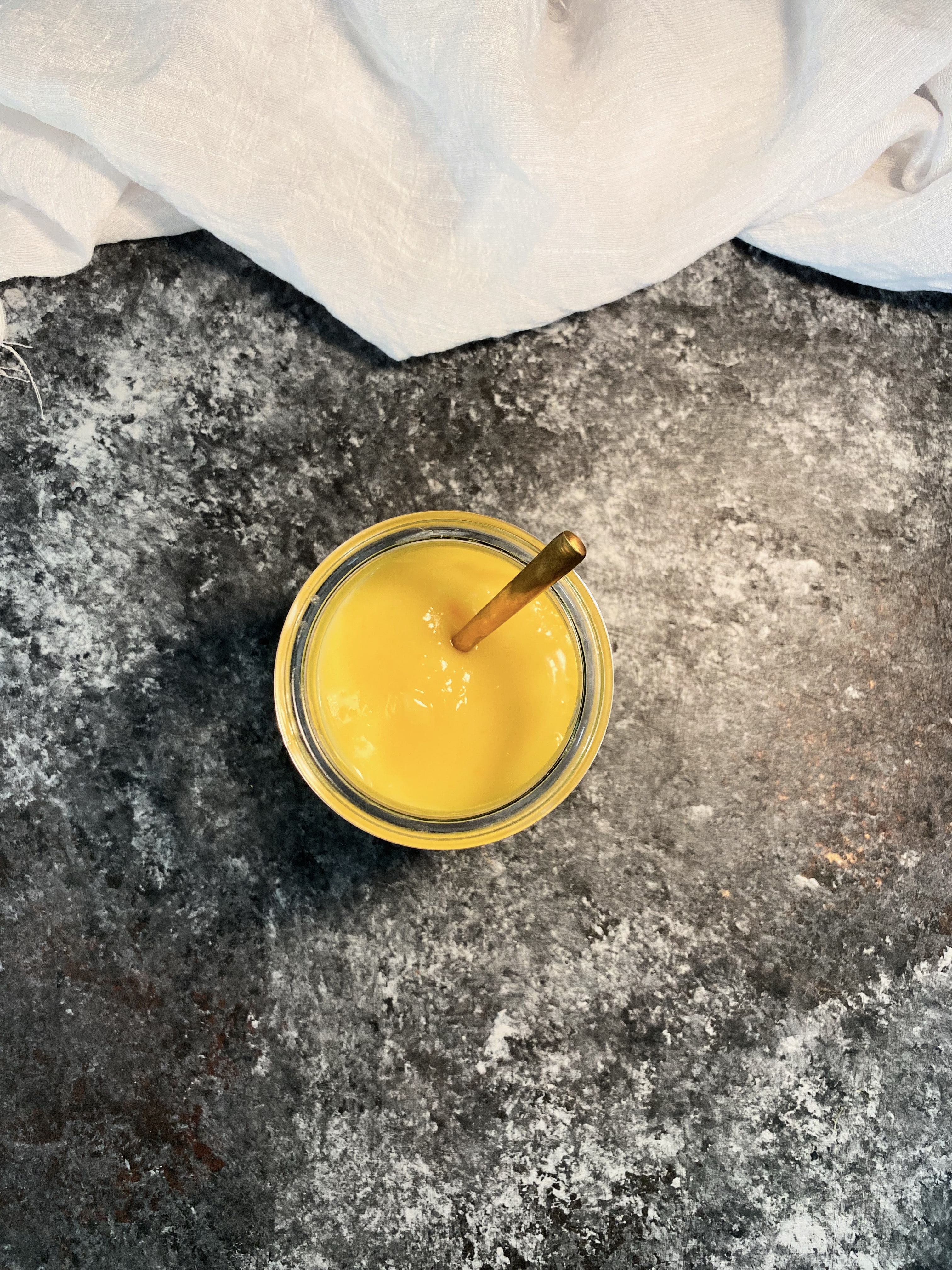 Small jar of lemon curd shot from overhead