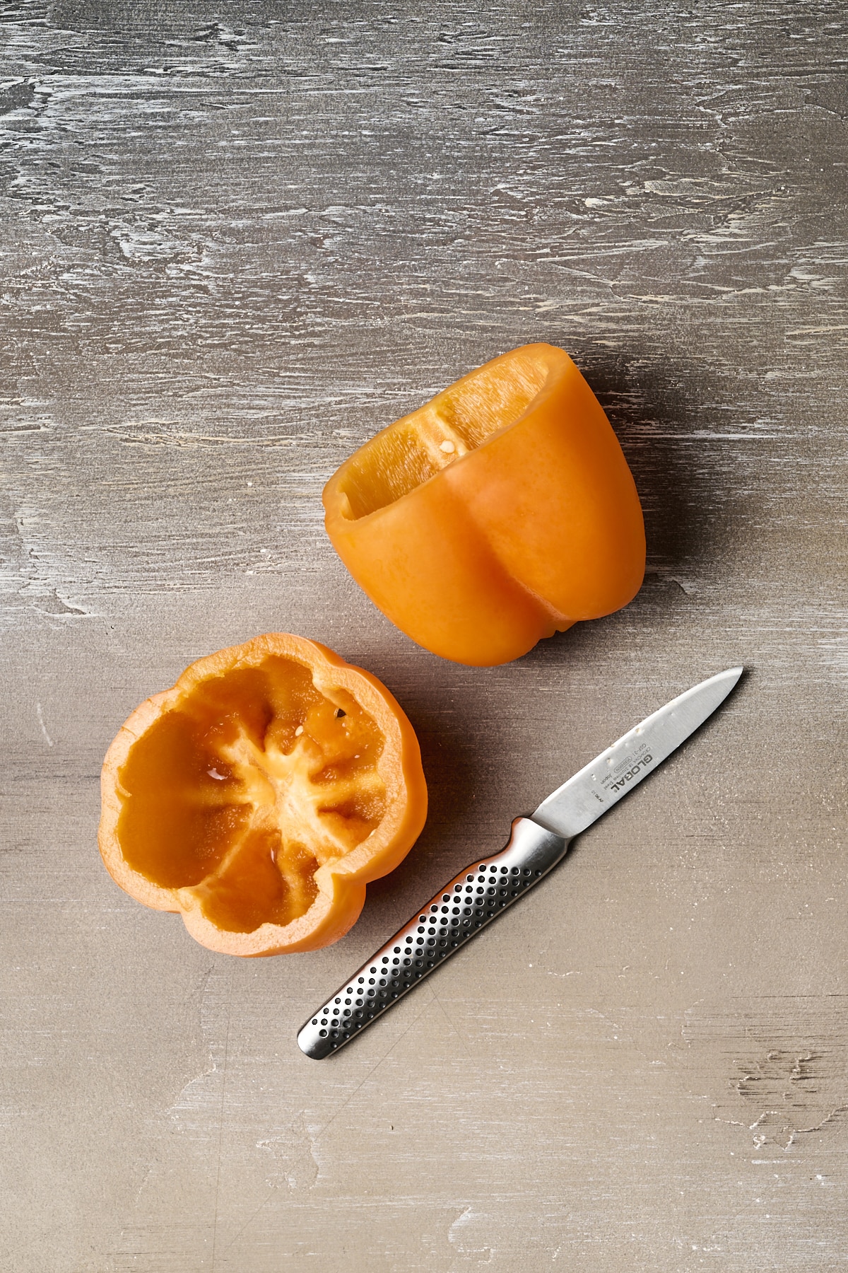 Two cored orange bell peppers