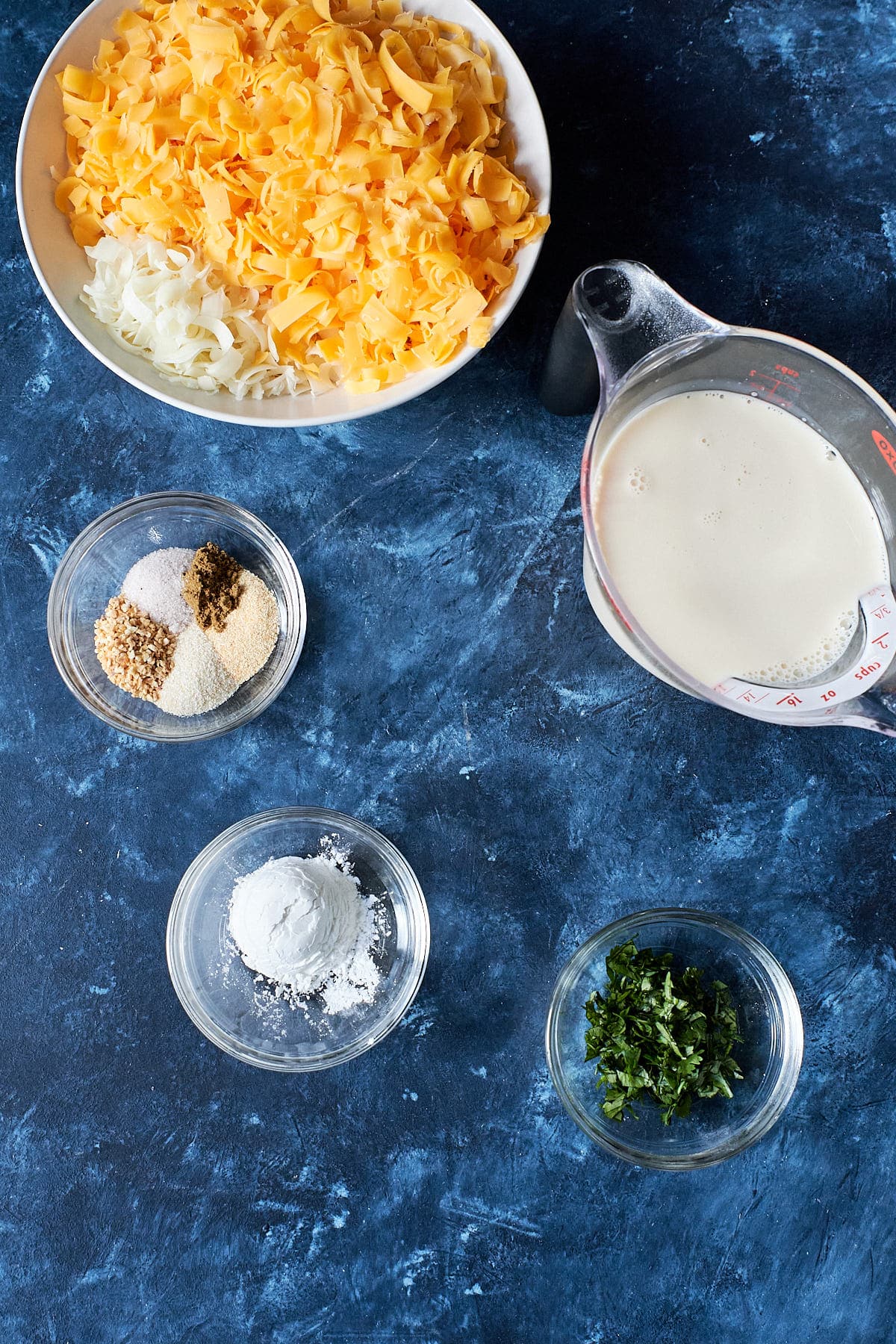 Queso ingredients - shredded cheese, evaporated milk, spices and cilantro