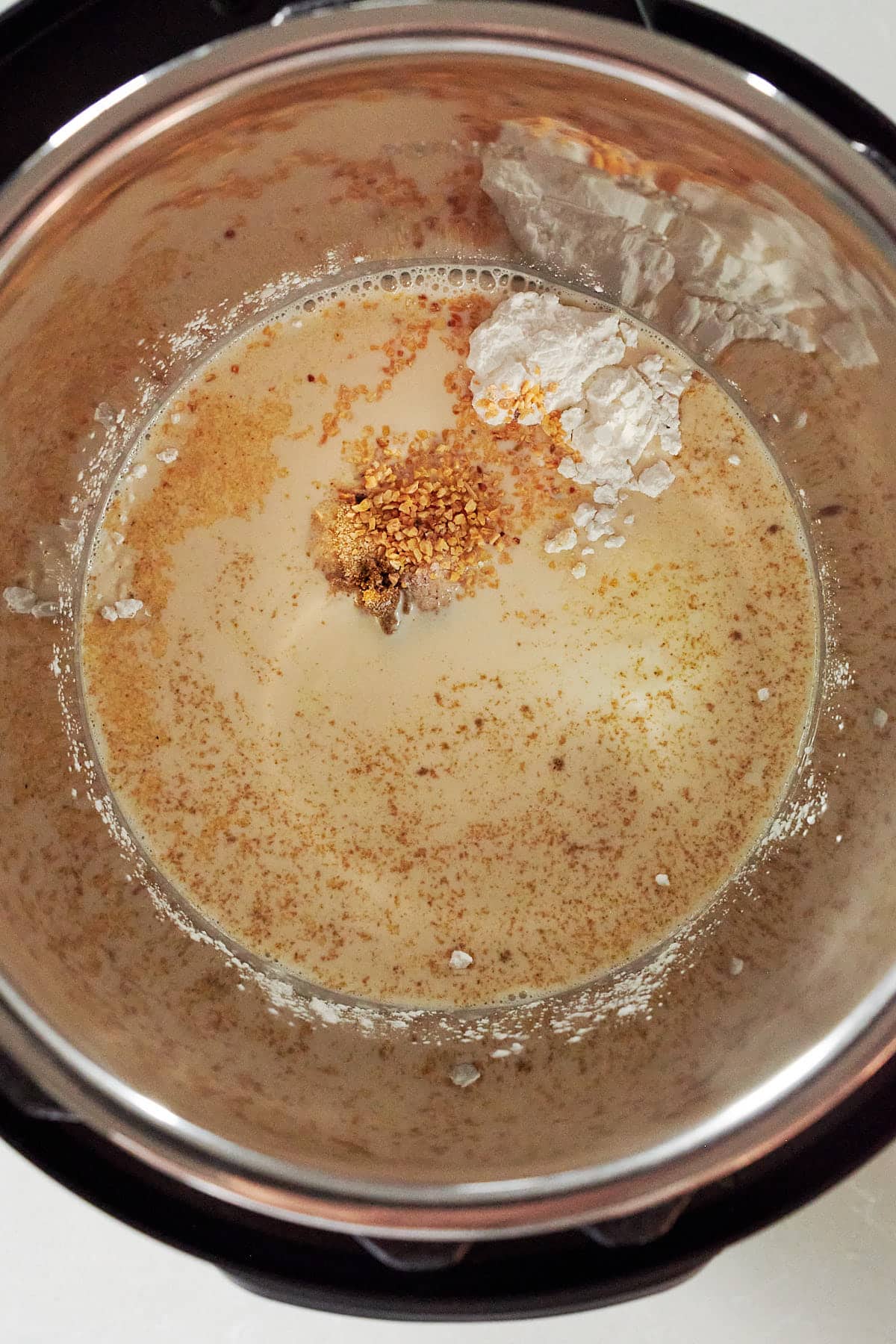 Evaporated milk and spices for cheese dip in the Instant Pot