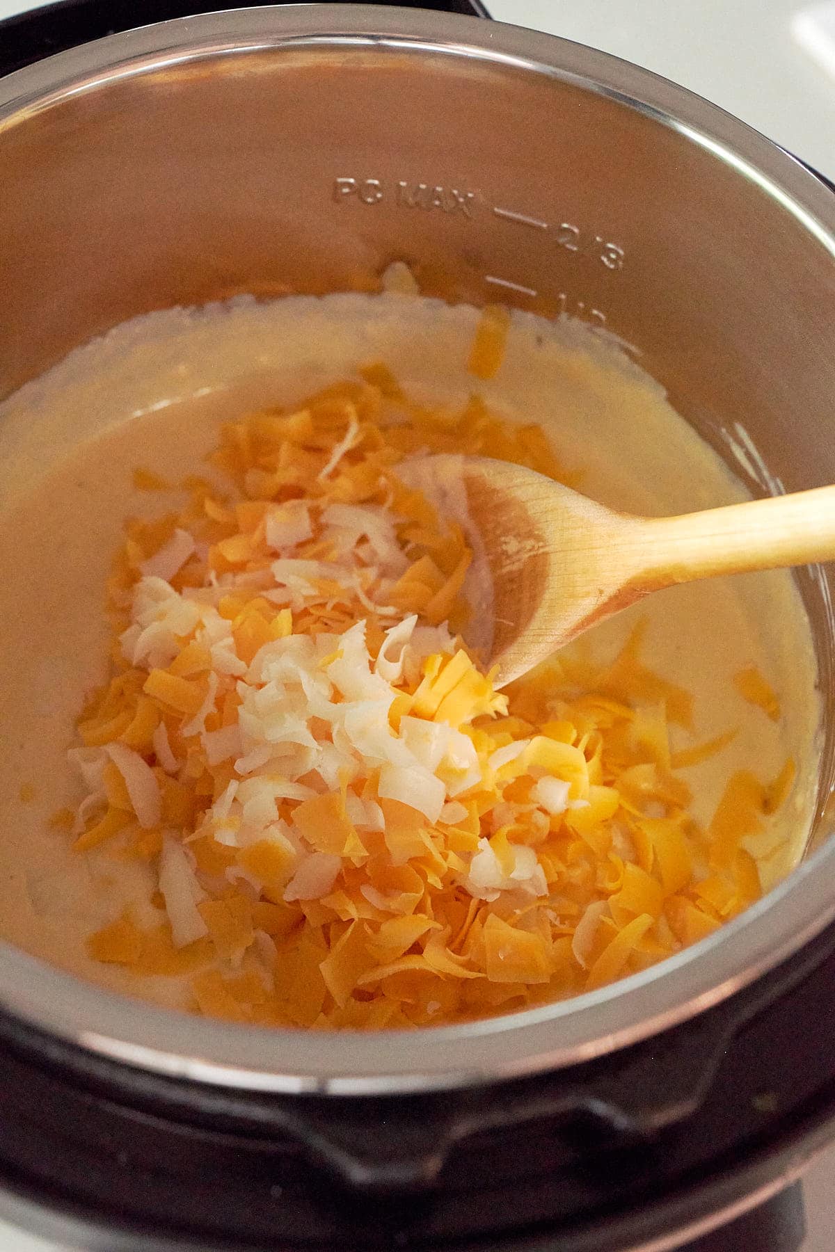 Stirring cheese into queso dip in the Instant Pot