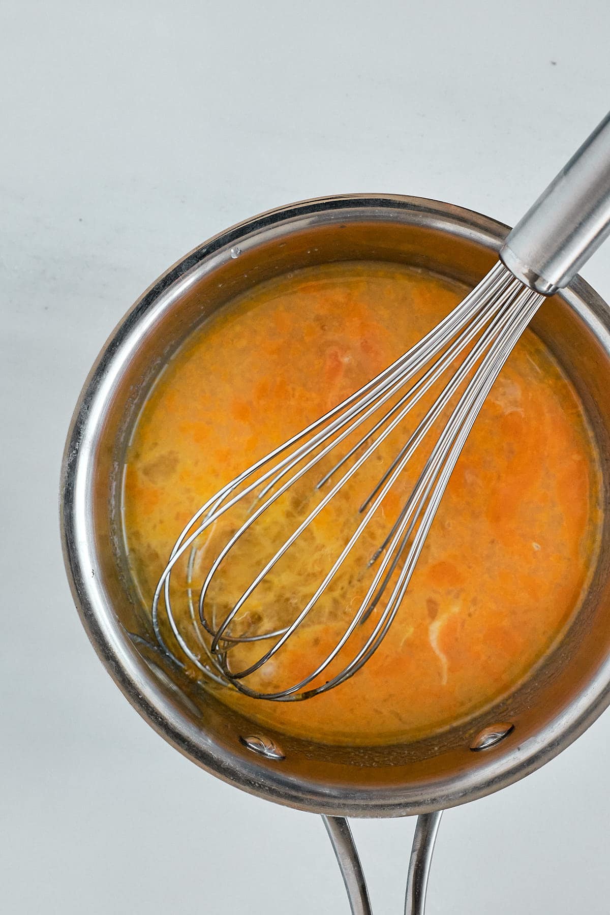 Lemon sugar, lemon juice and eggs cooking in a small pan