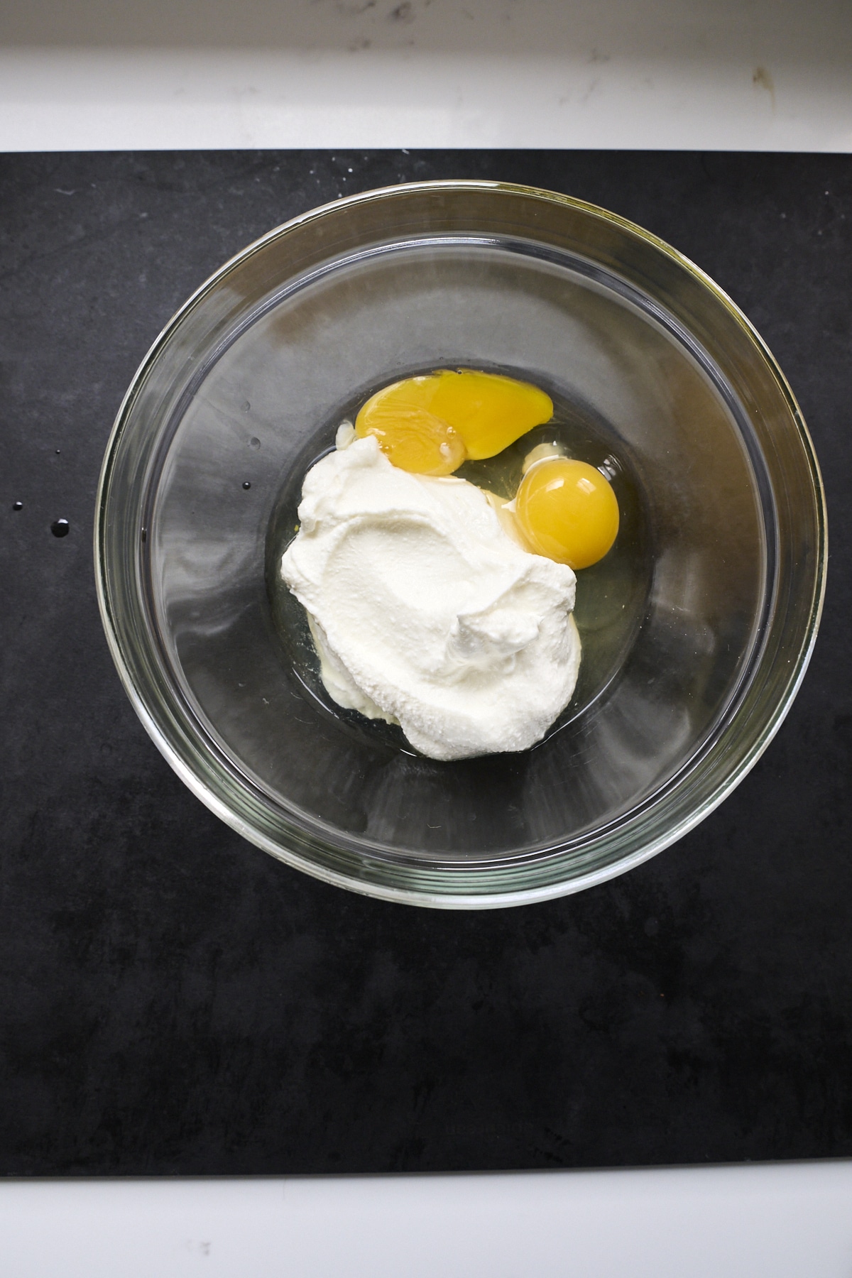Ricotta and egg yolks in a glass bowl
