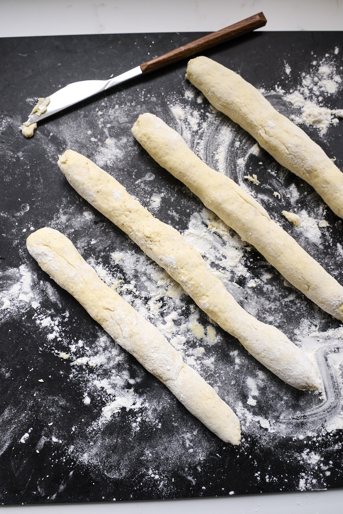 Ricotta gnocchi dough rolled into tubes before cutting