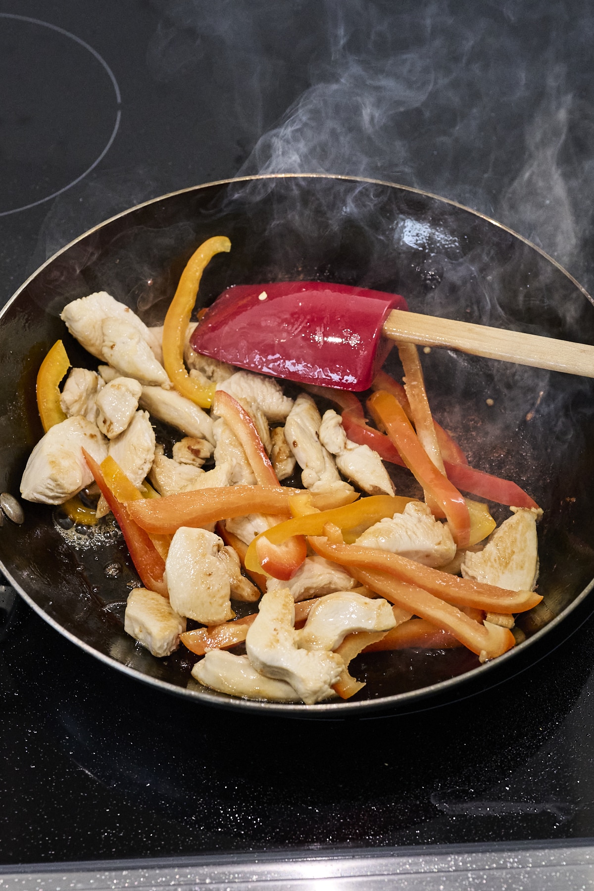 chicken and veggies cooking in wok