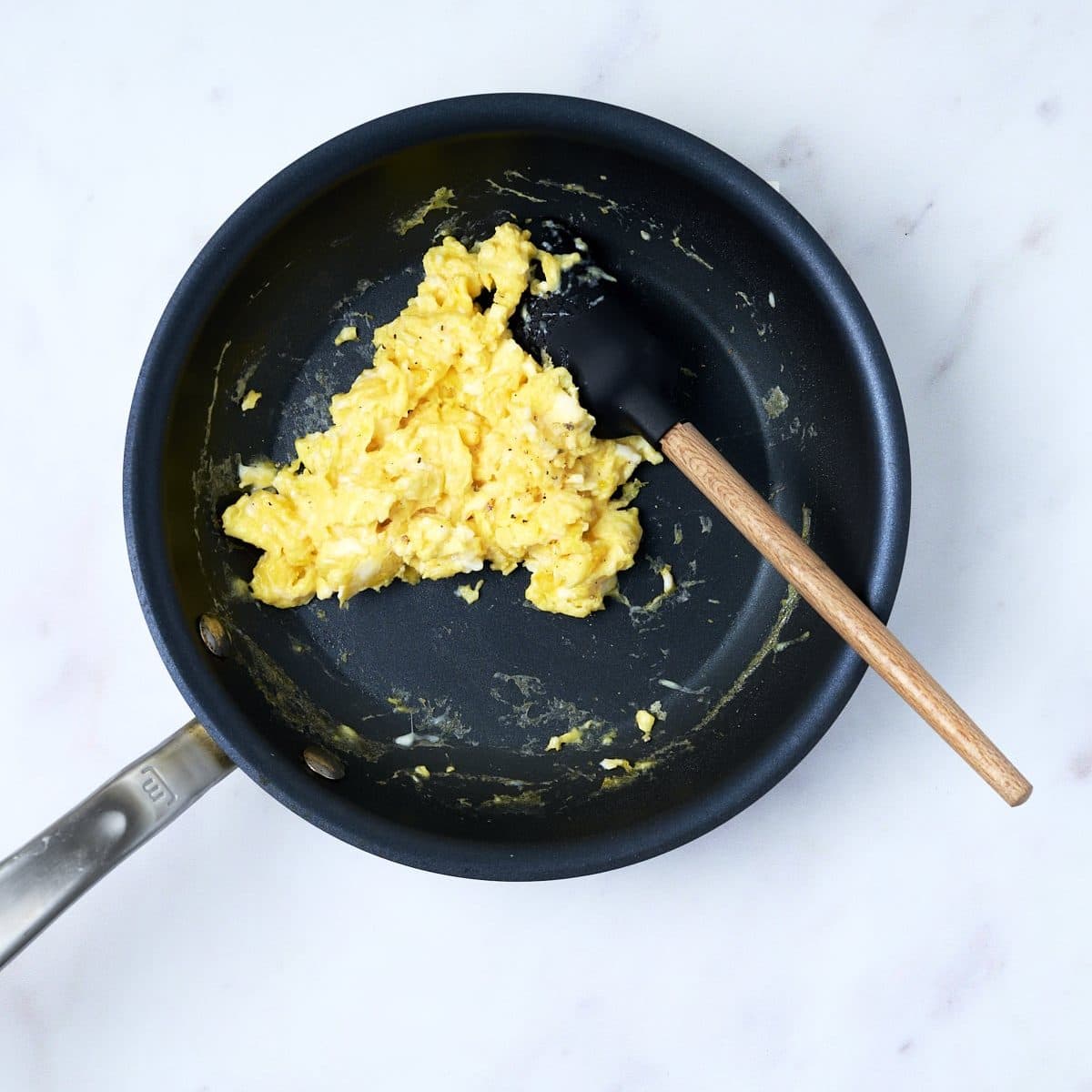 Scrambled eggs in a pan for breakfast quesadillas 