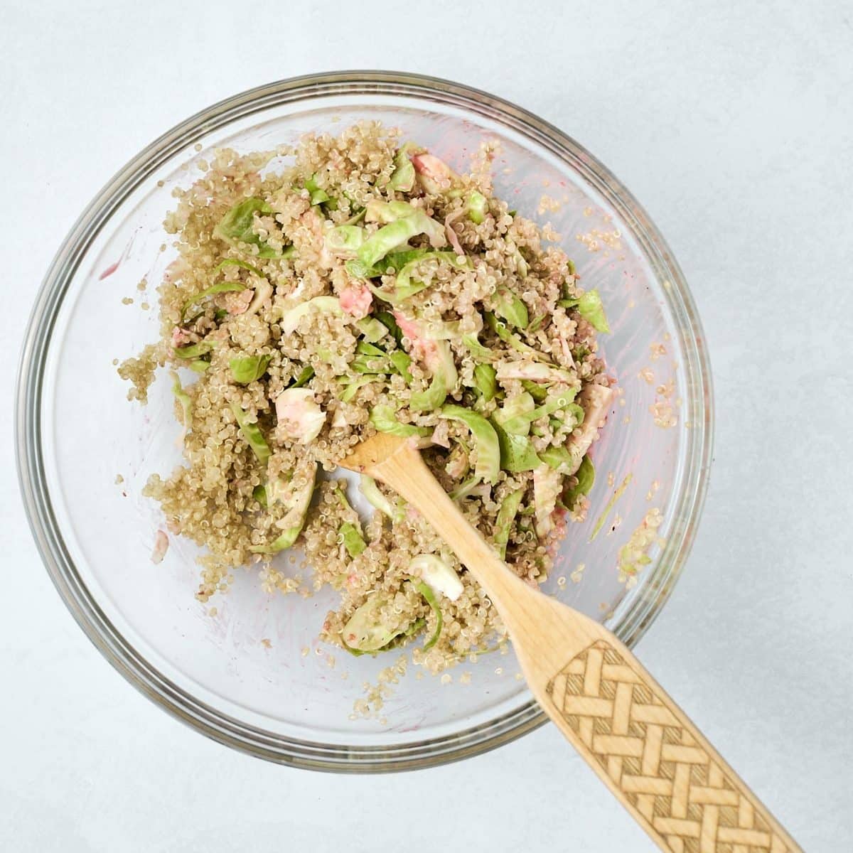 Quinoa, shaved brussels sprouts and raspberry dressing in a bowl