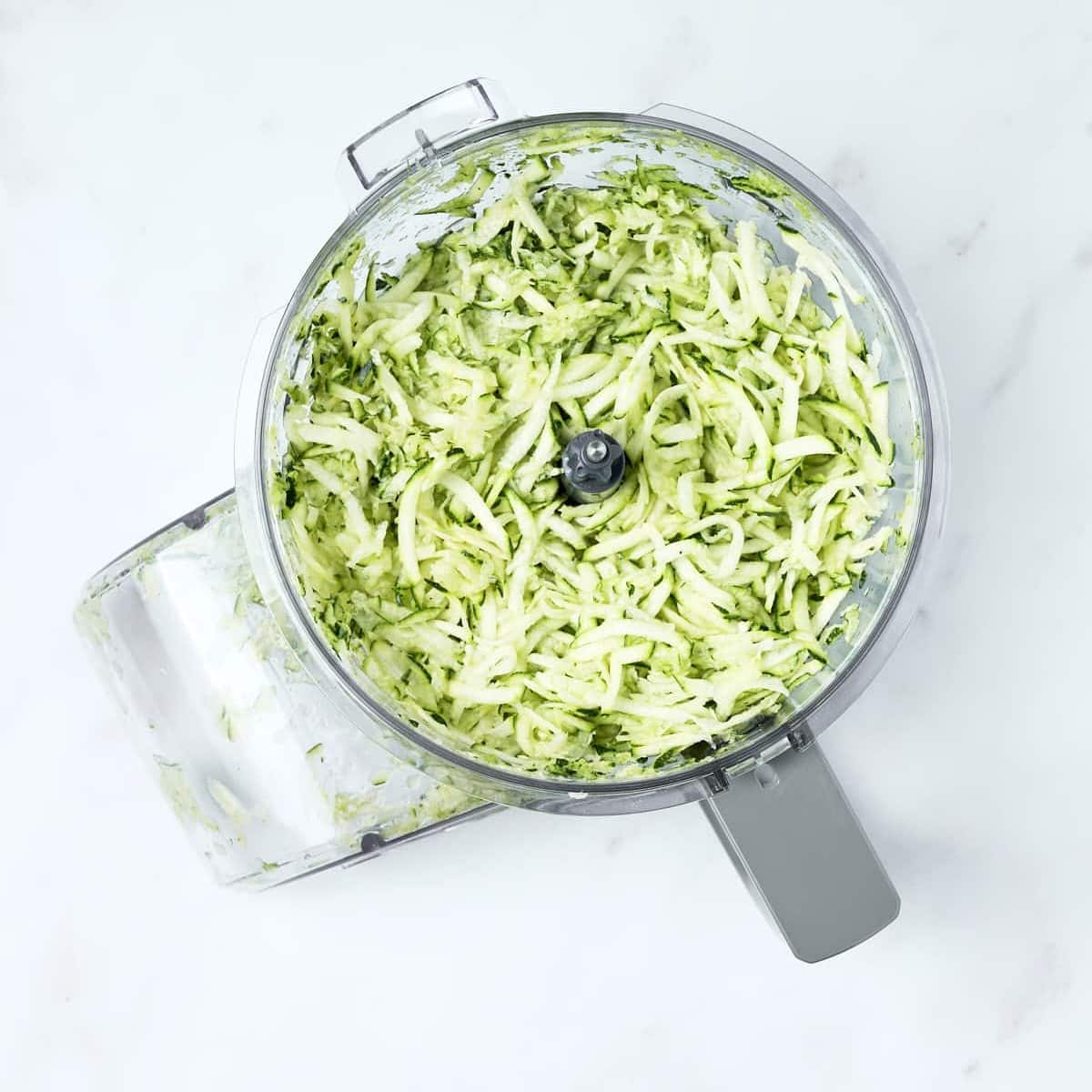 Shredded zucchini in a food processor