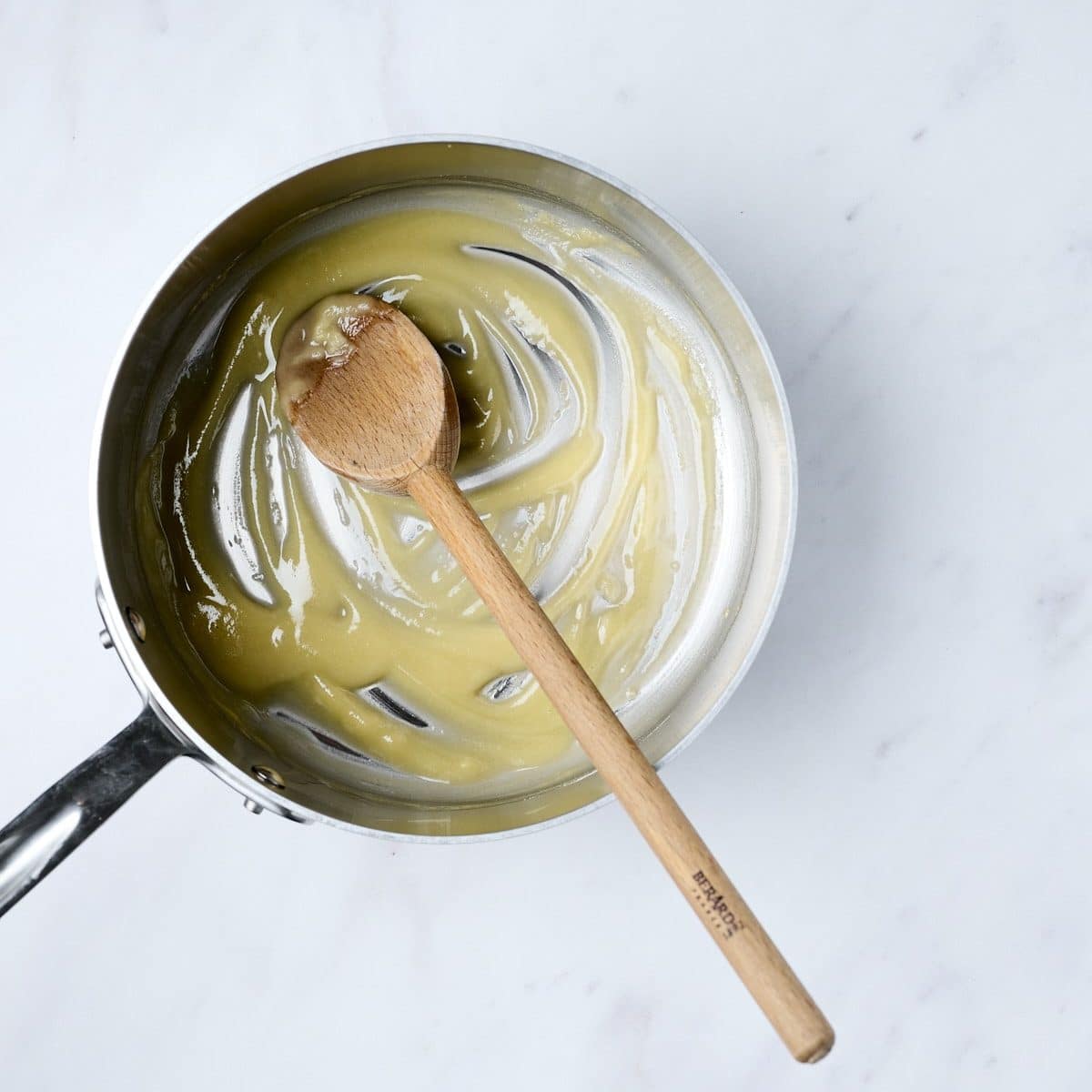 Butter and flour, ingredients for roux, mixed in a sauce pan