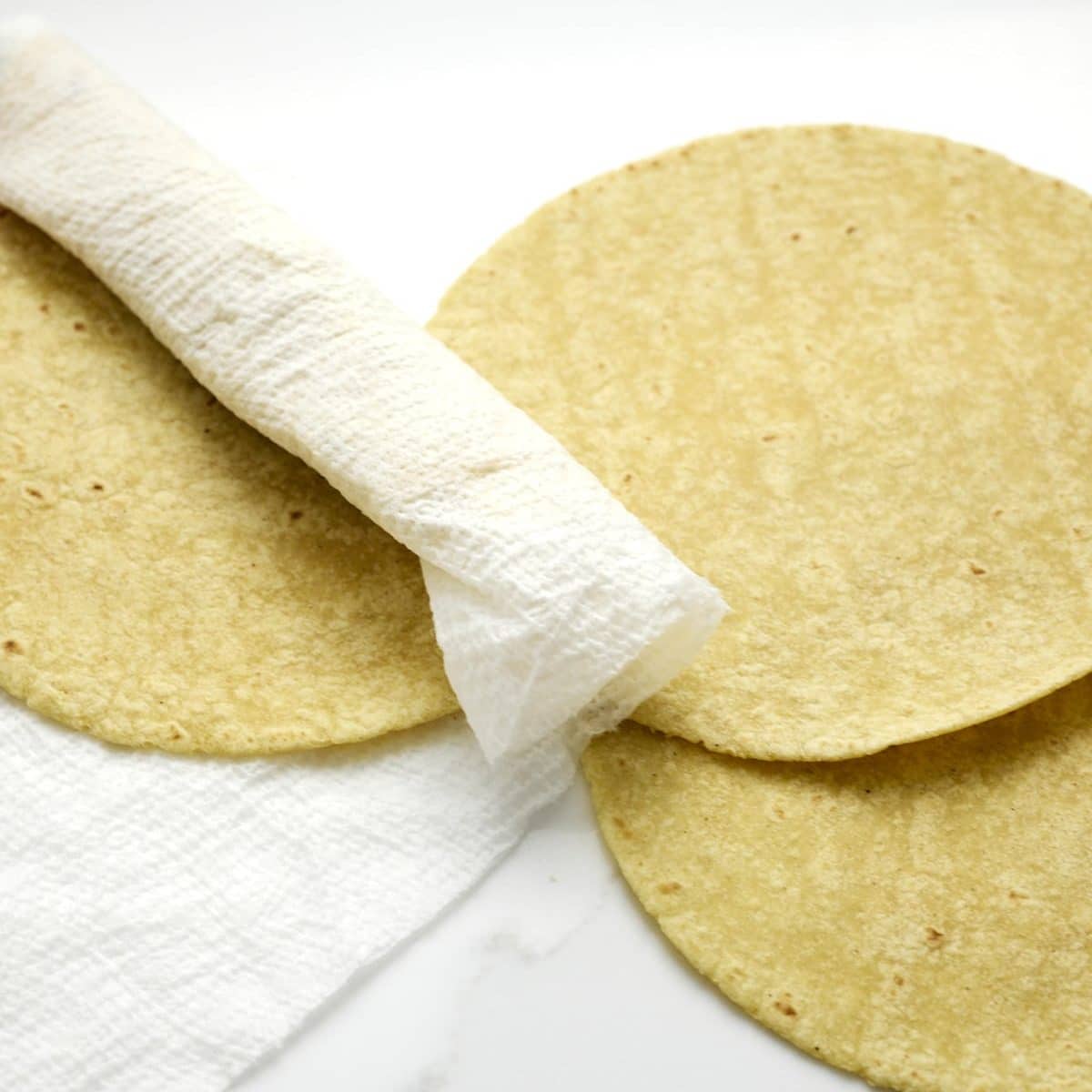 Corn tortillas wrapped for steaming in microwave