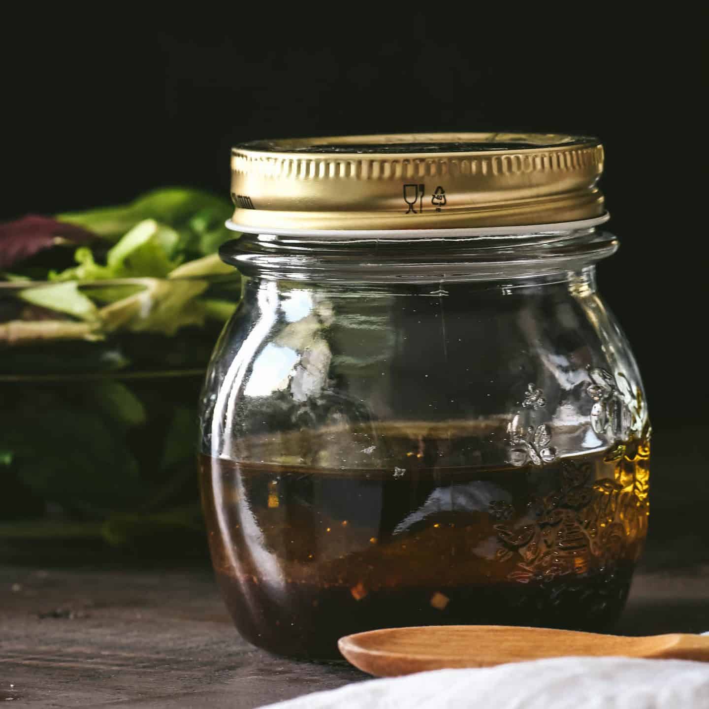 Small mason jar of homemade balsamic vinaigrette dressing