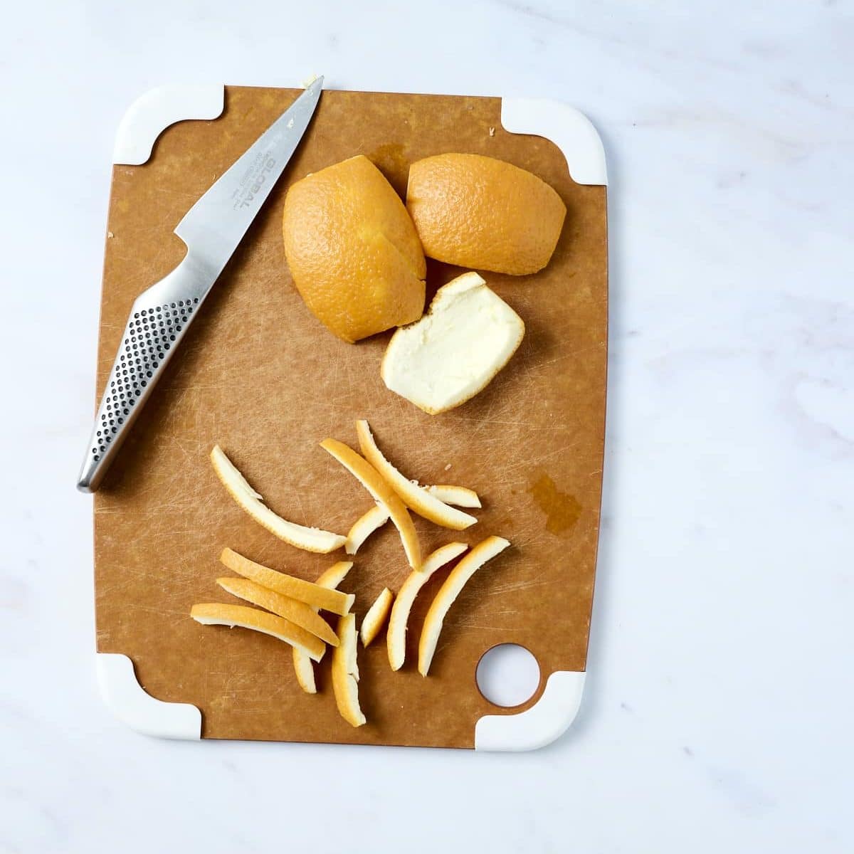 Sliced orange peels on a cutting board