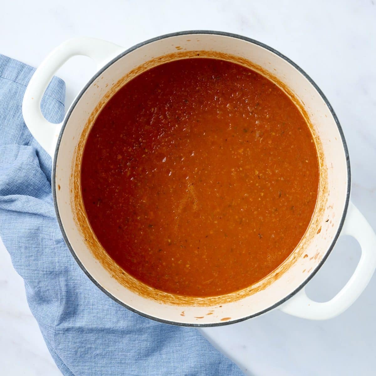 White dutch oven with pureed tomato bisque