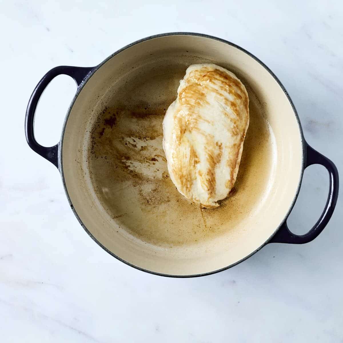 Seared chicken breast in a dutch oven