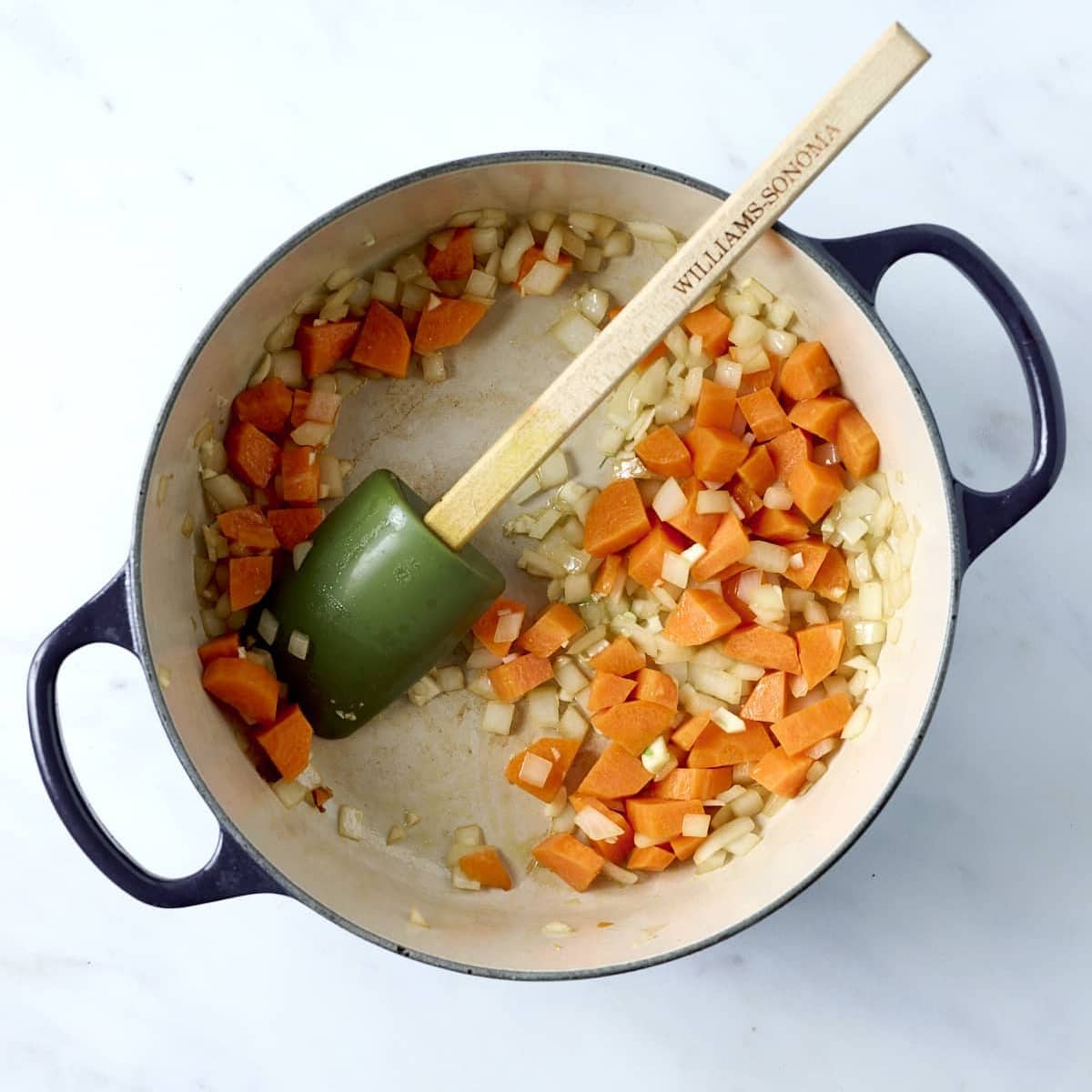 Sauteed carrots and onions in a dutch oven