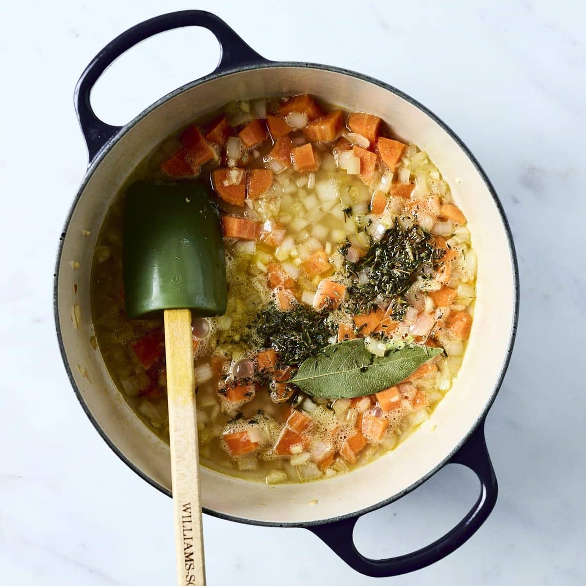Sauteed veggies, chicken broth, herbs and bay leaf in a dutch overn