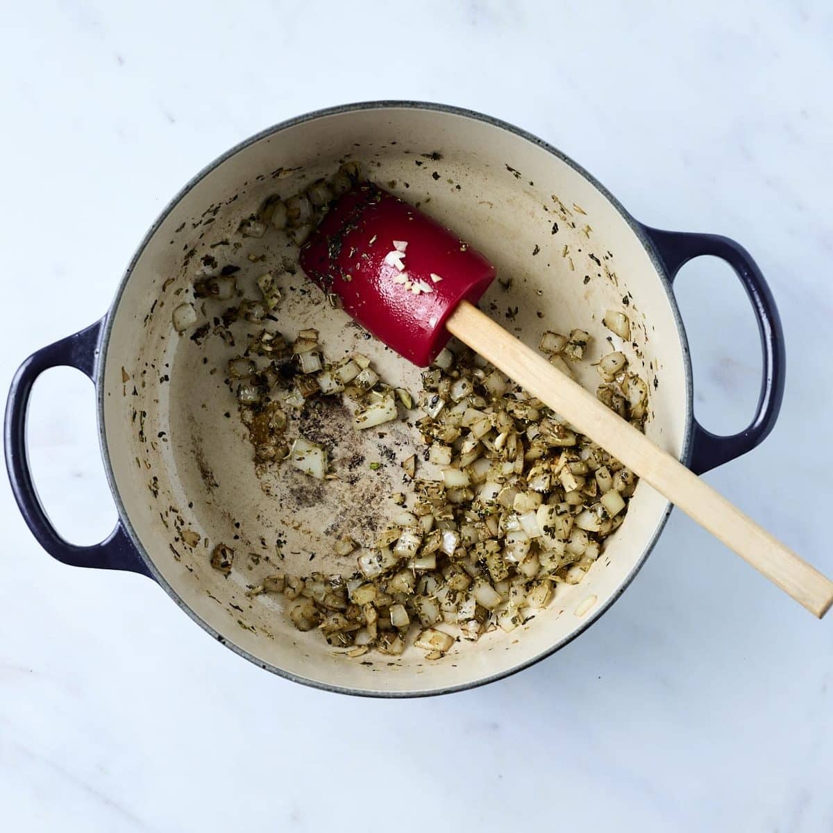 Onions and garlic cooking in a dutch oven