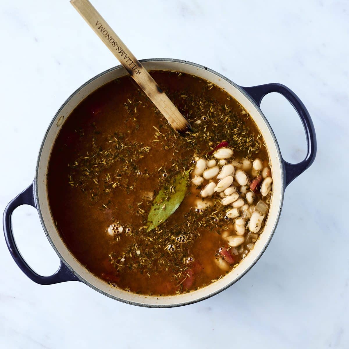 Tomato based soup broth simmering in a dutch oven