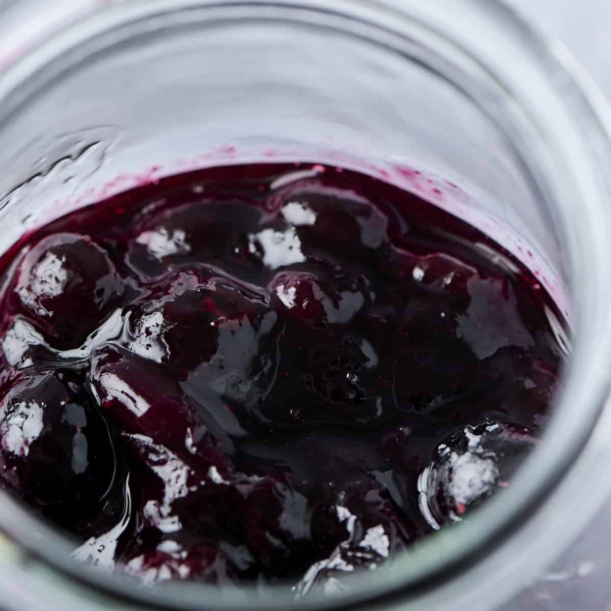 Cooled blueberry compote in a small glass jar