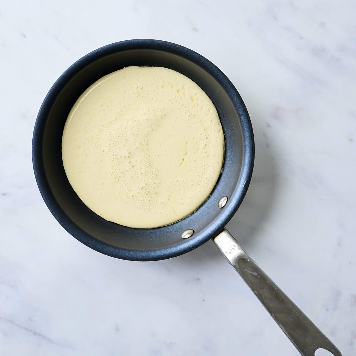 Cottage cheese pancake batter in a small pan