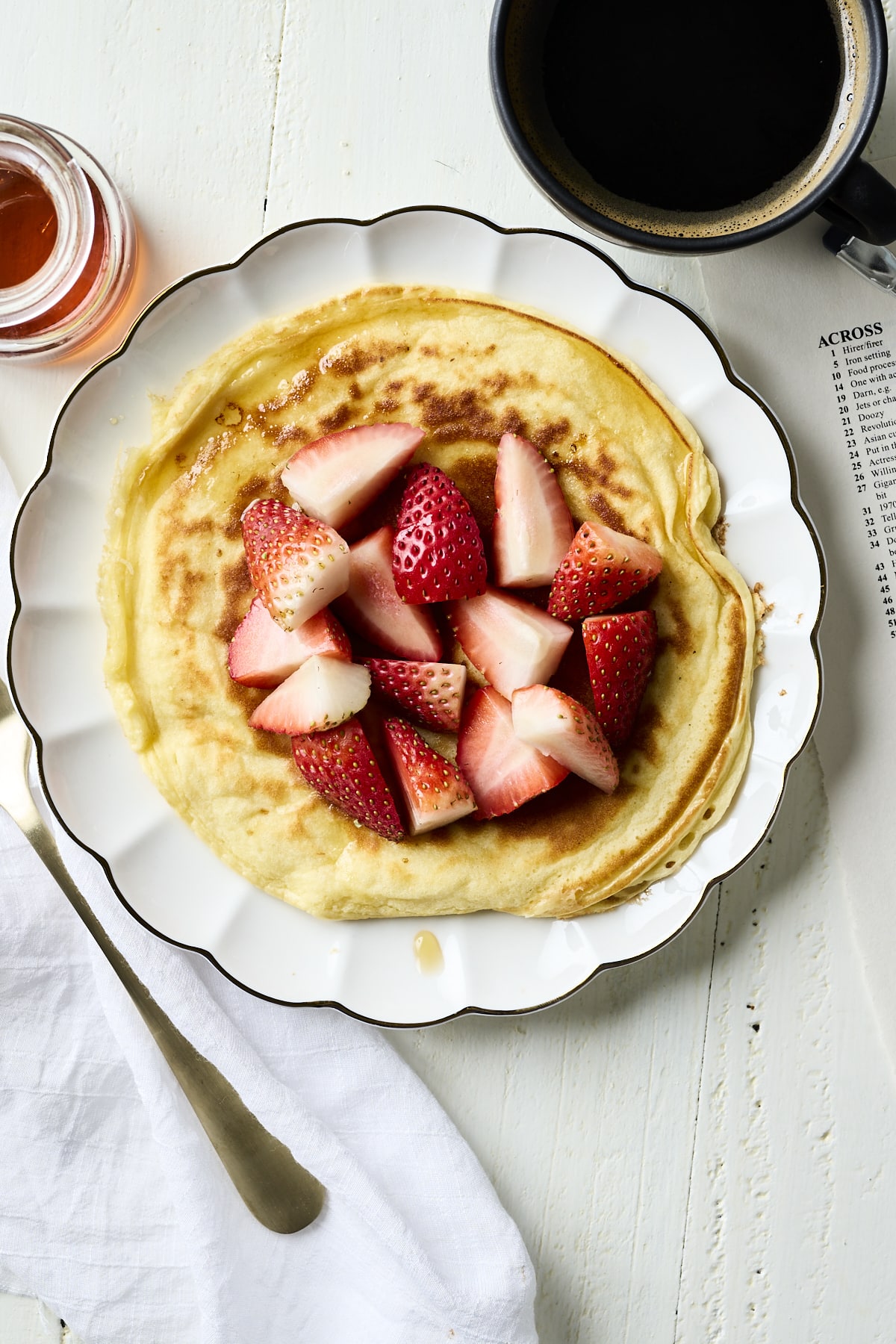 Single serve cottage cheese pancake topped with sliced strawberries
