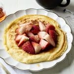 Cottage cheese pancake on a plate with a cup of coffee