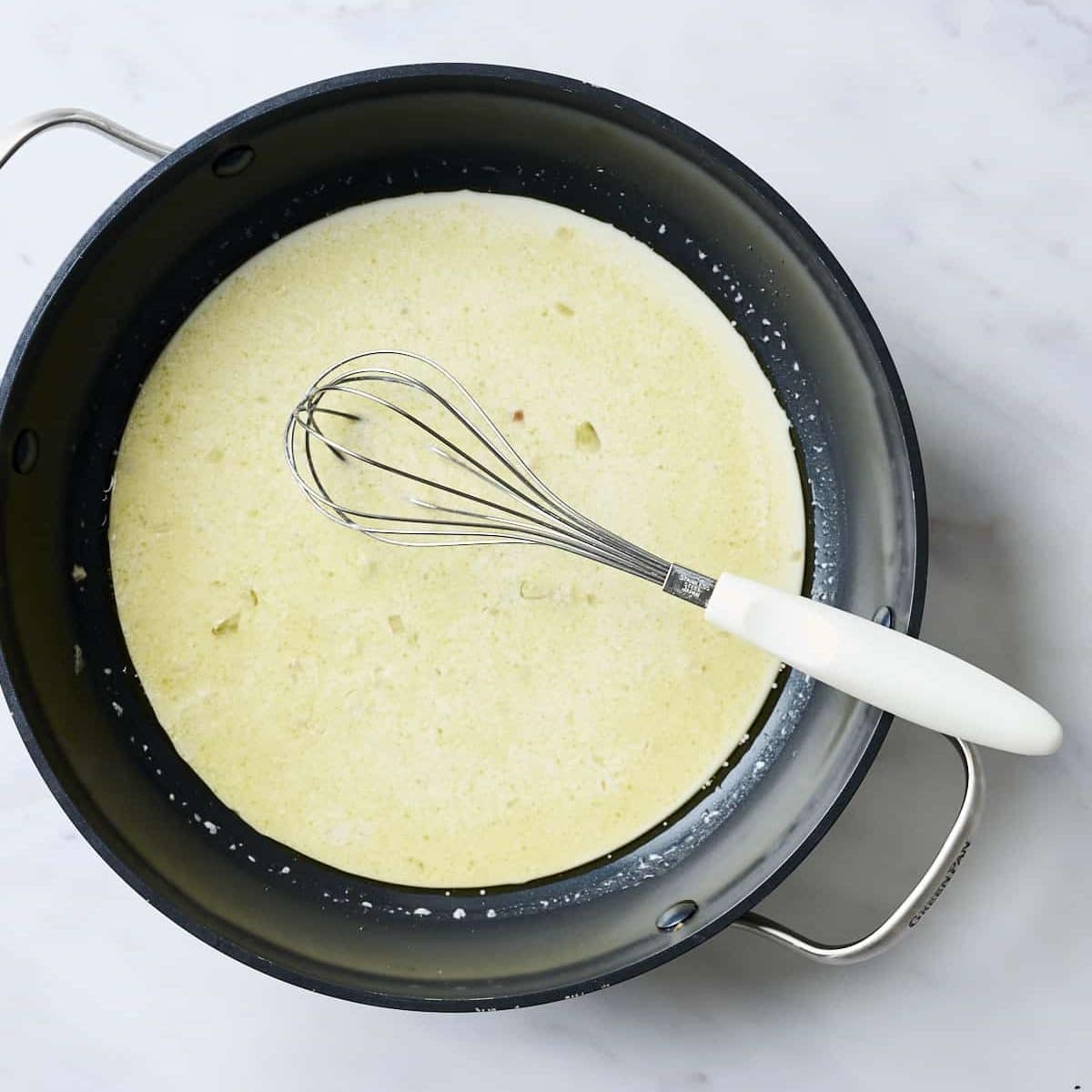 White wine, lemon juice and cream mixed in a pan for lemon pasta sauce