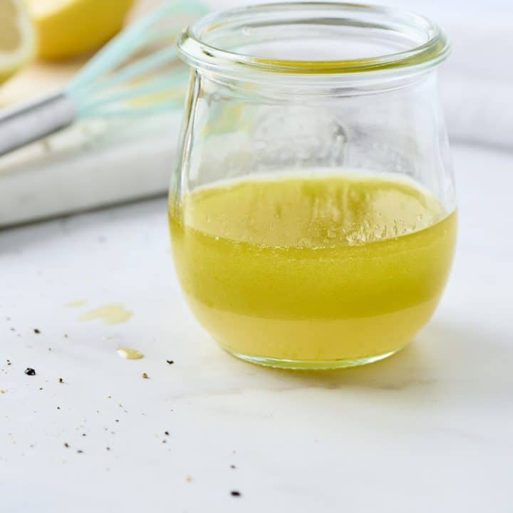 Lemon vinaigrette dressing in a small glass jar