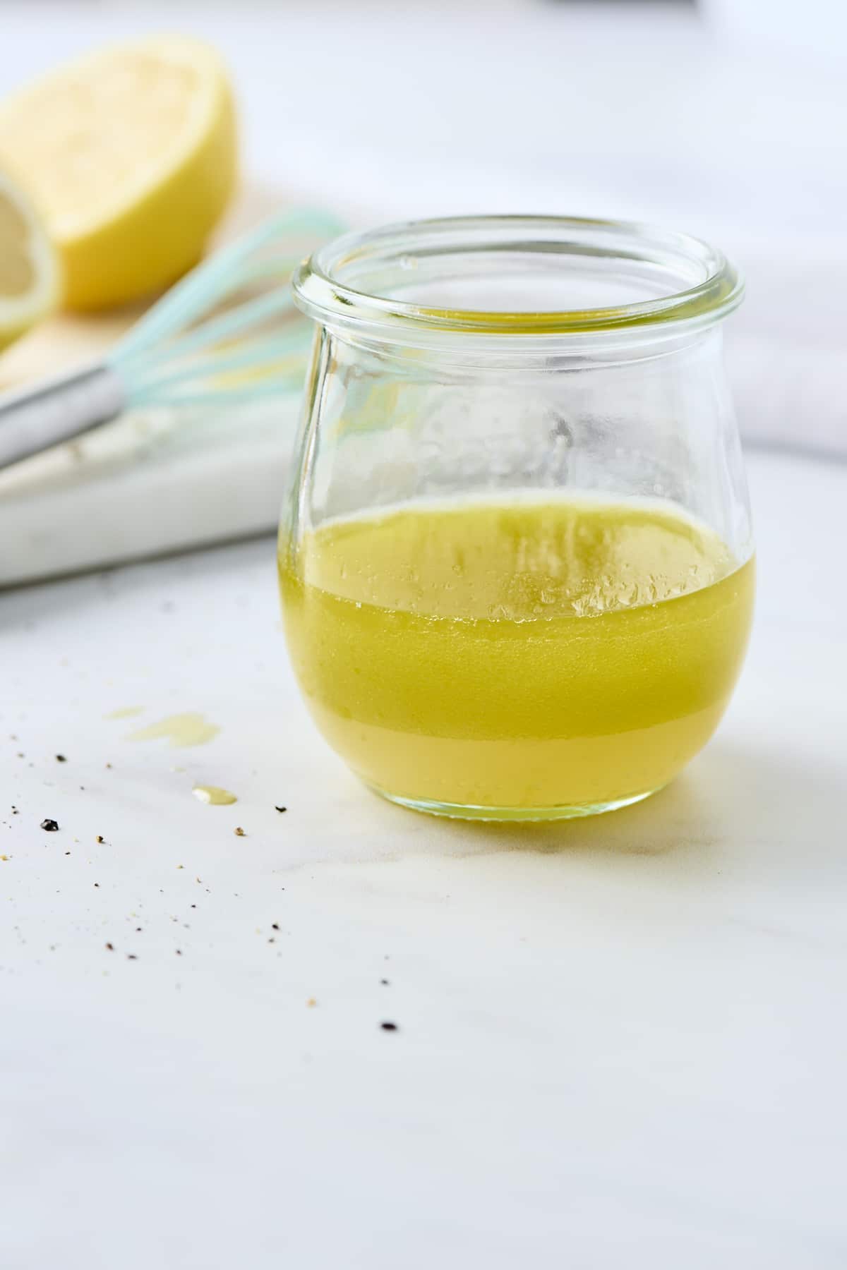 Lemon vinaigrette dressing in a small glass jar
