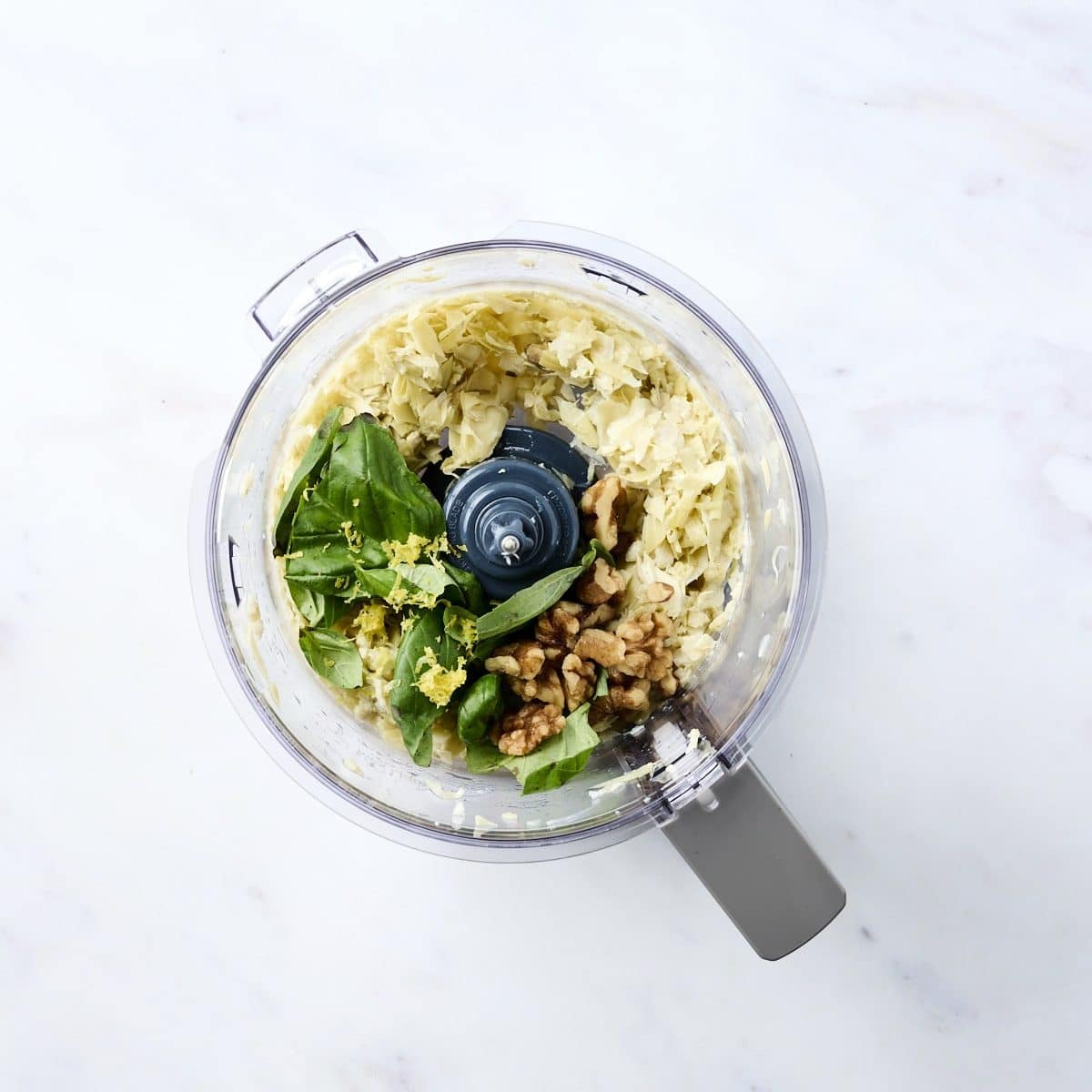 artichoke hearts, basil, lemon juice and walnuts in a food processor
