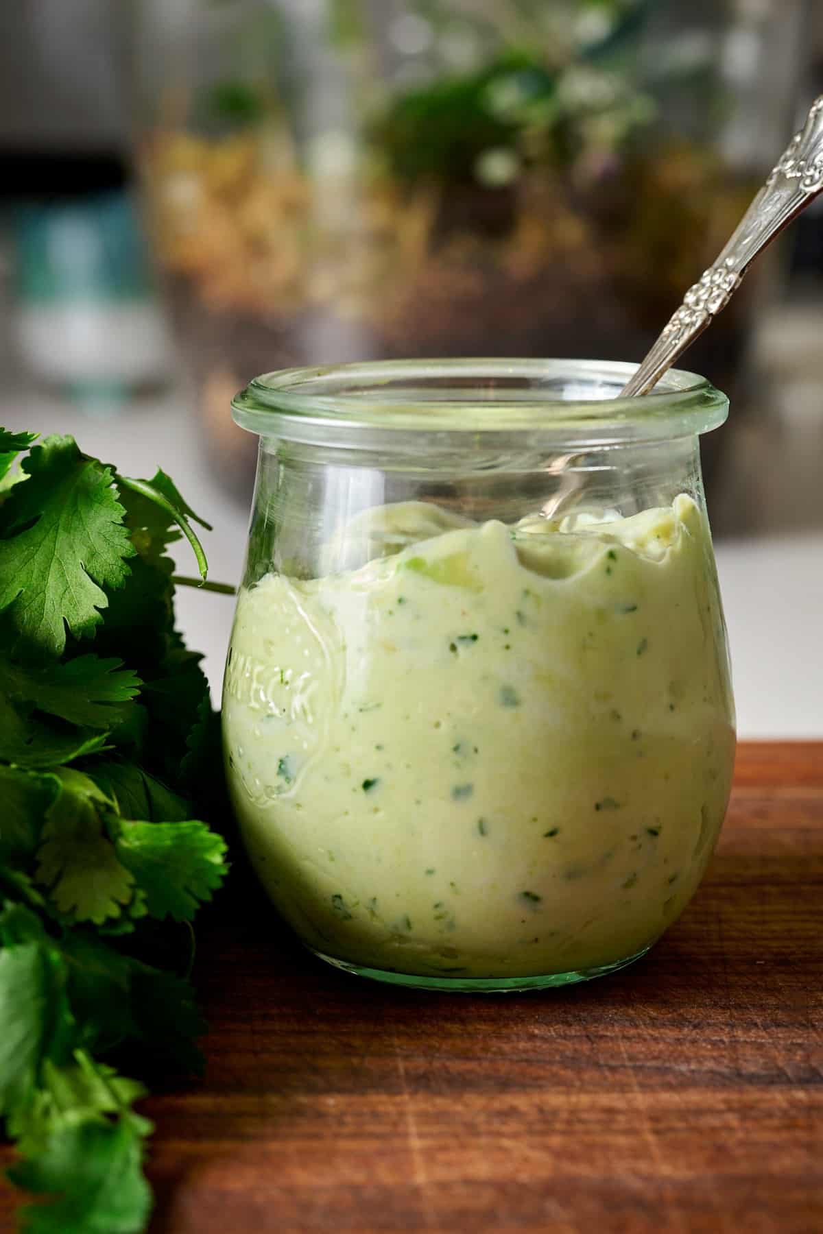 Cilantro Avocado sauce in a glass jar.