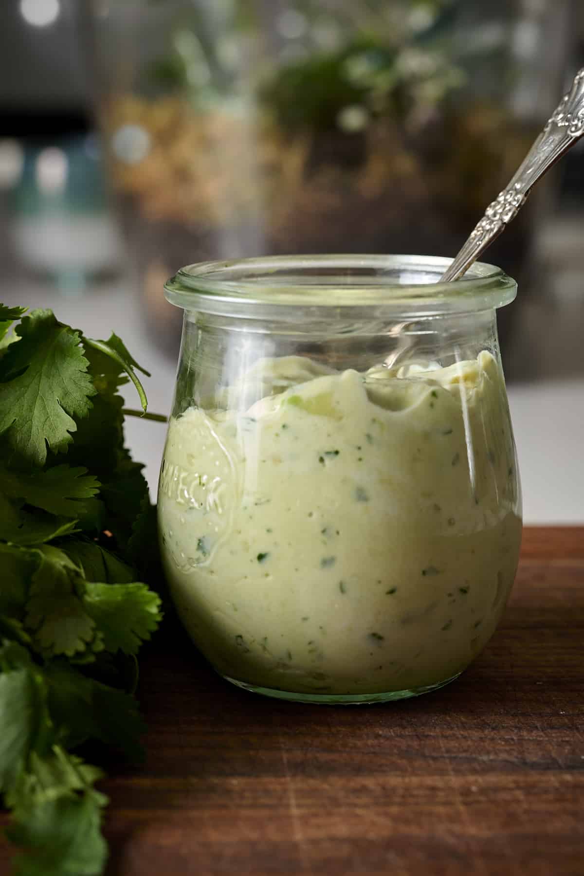Cilantro Avocado sauce in a glass jar. 
