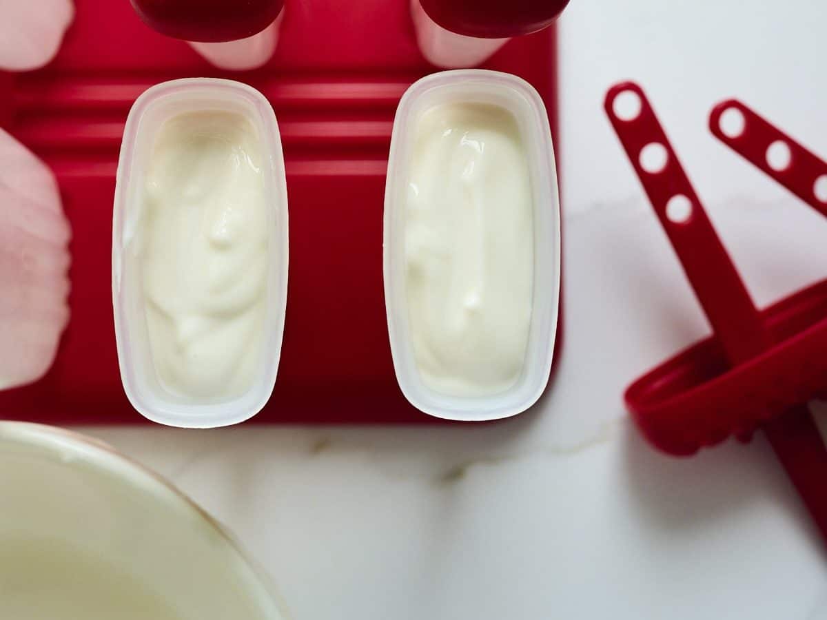 Lemon greek yogurt mixture in popsicle molds before freezing