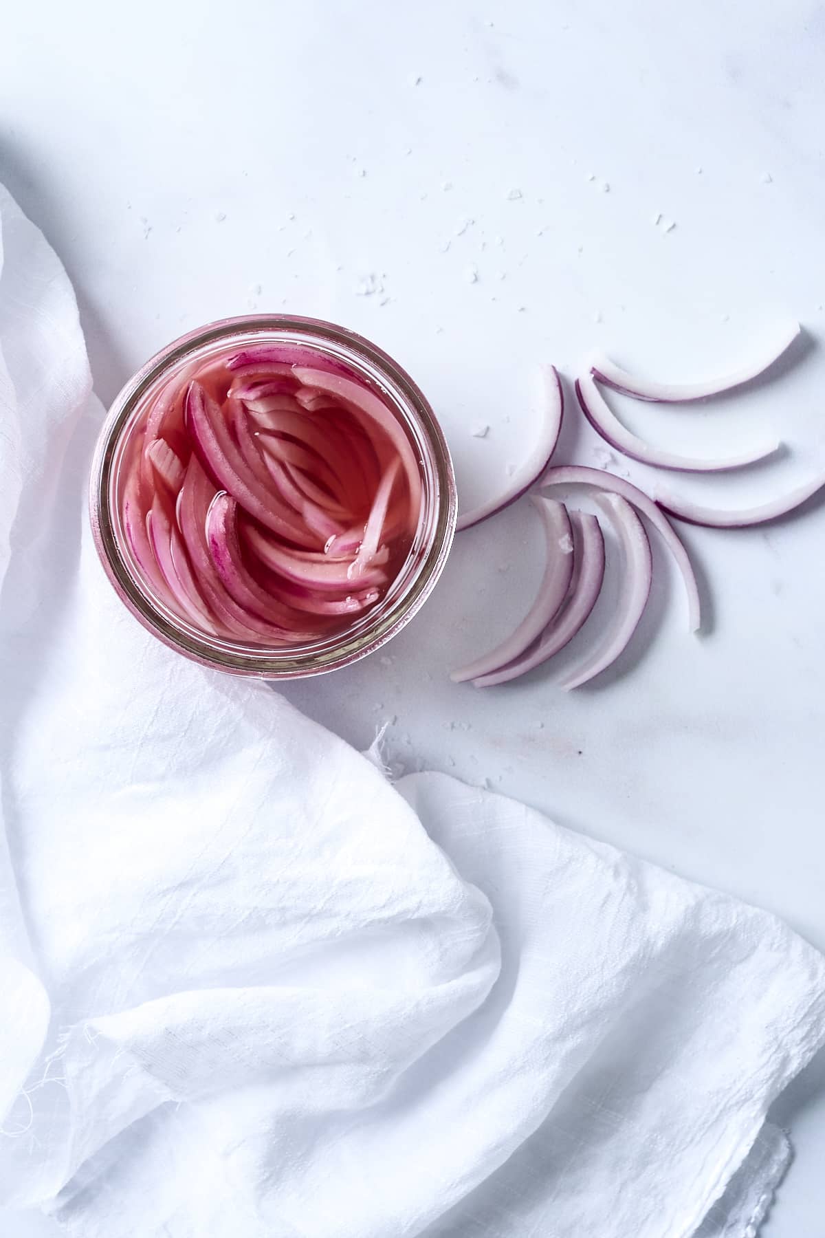 Overhead shot of pickled red onions in a glass jar