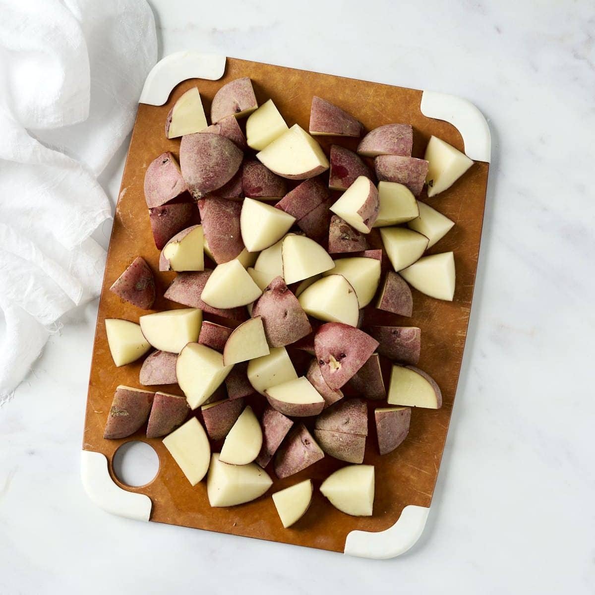 Chopped red skin potatoes on a cutting board