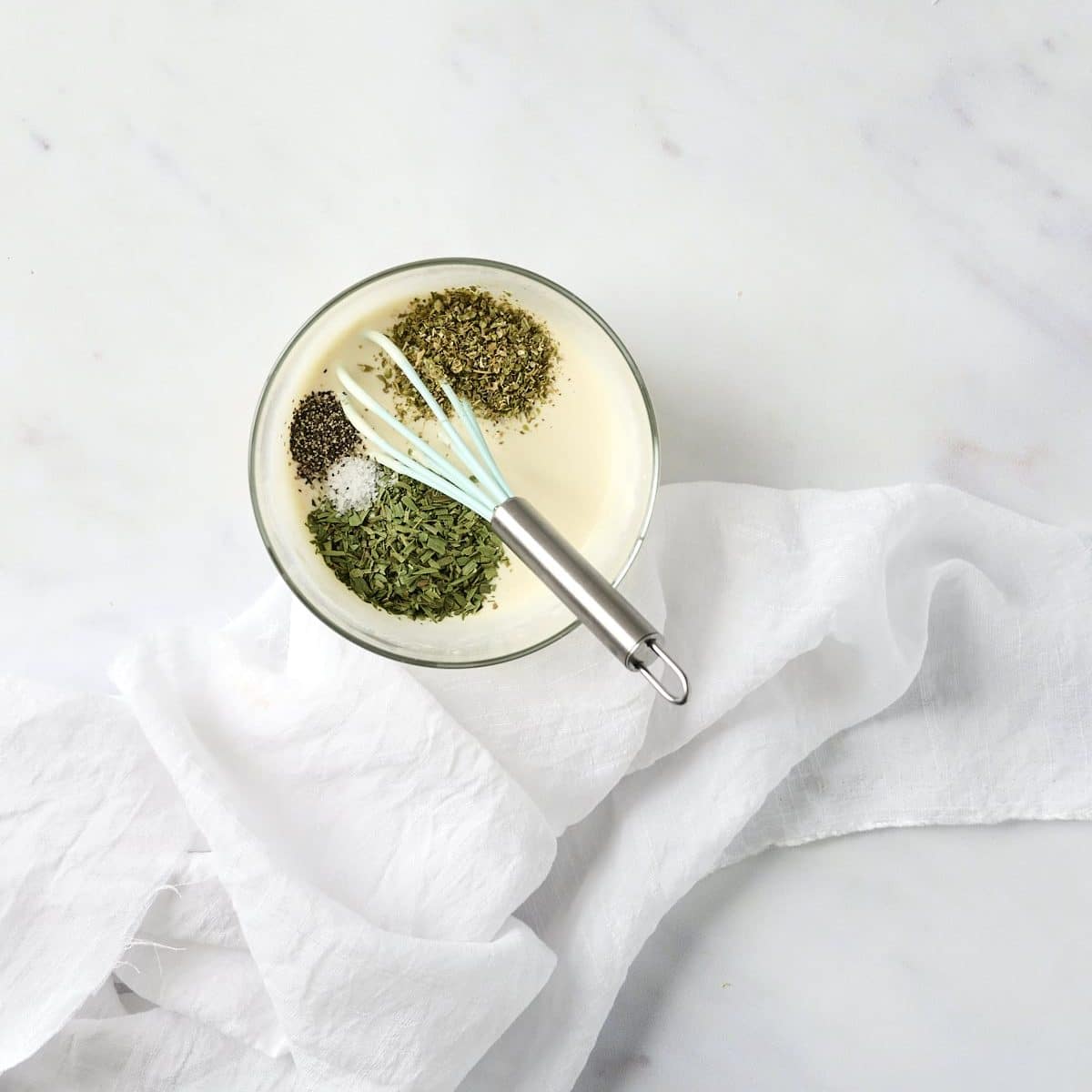 Mayonnaise and champagne vinegar with spices in a small glass bowl