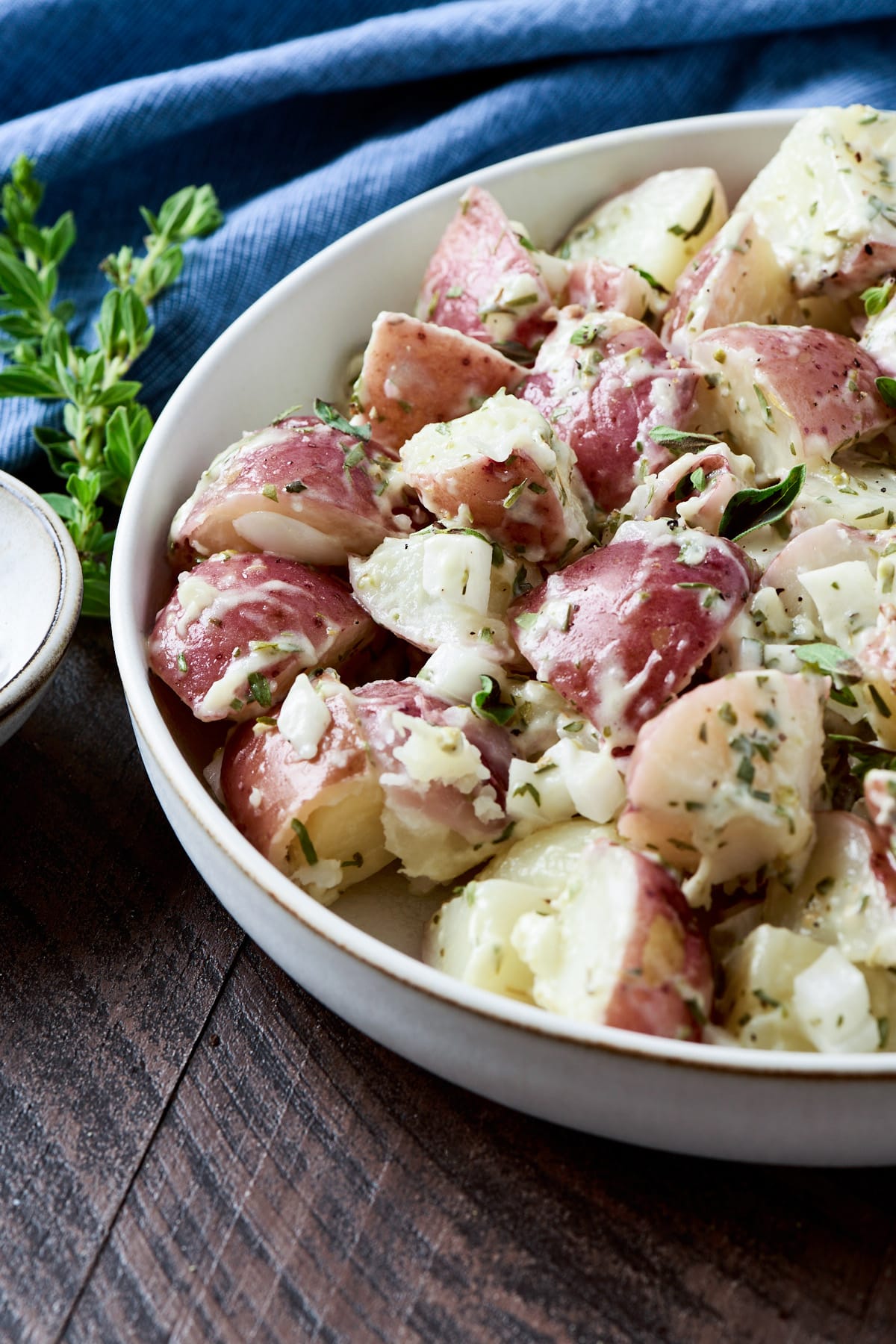 Red skinned potato salad in a low cream bowl